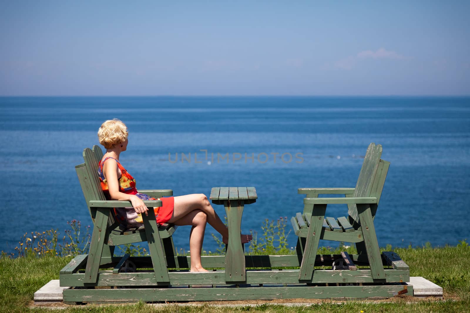 Girl having a beautiful moment on a bench in vacation