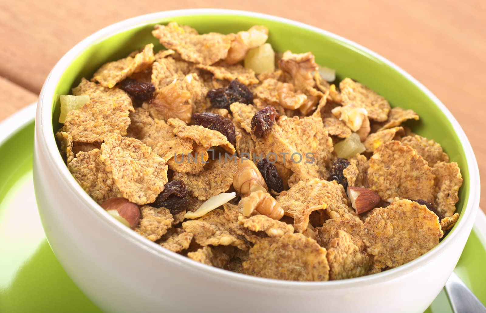 Wholewheat cereal with dried fruit, raisin, walnut and almond in bowl (Selective Focus, Focus in the middle of the bowl) 