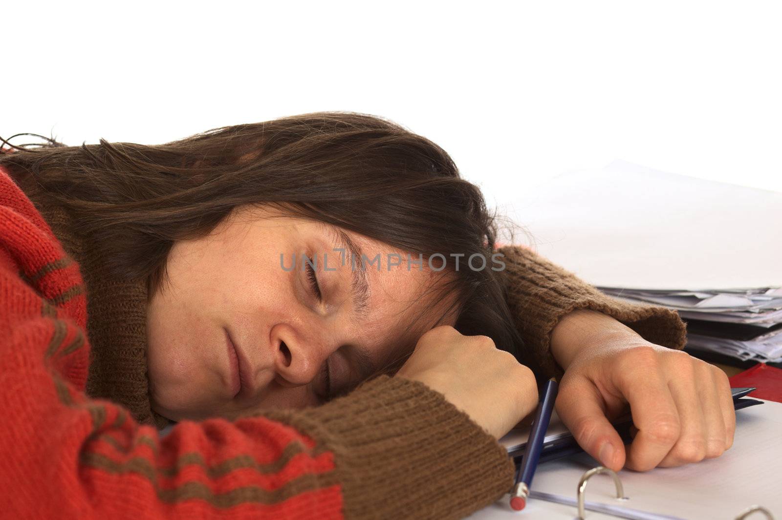 Young Caucasian woman fell asleep while writing and studying. Isolated on white (Selective Focus, Focus on the right eye and the right side of the face)