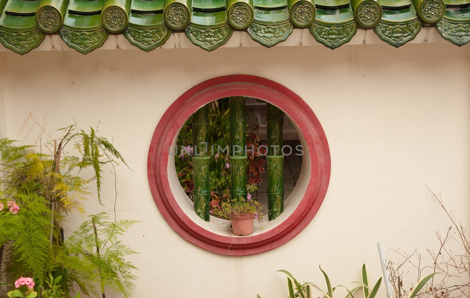 a round barred window in wall background