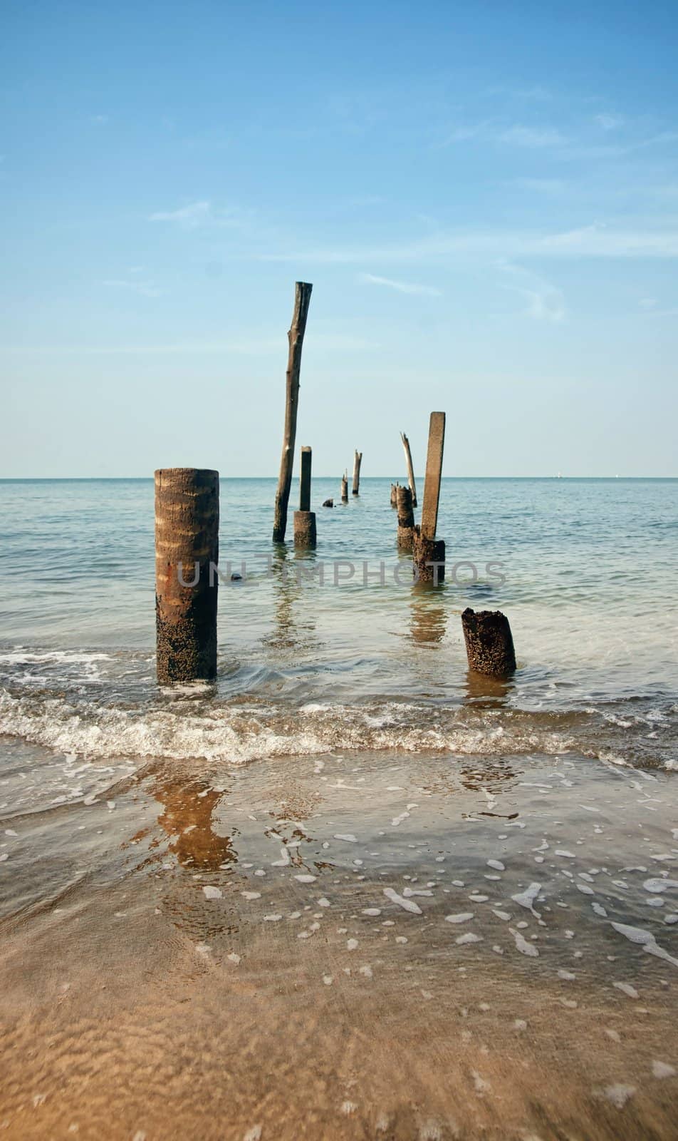 pillars from an old jetty stand in the sea