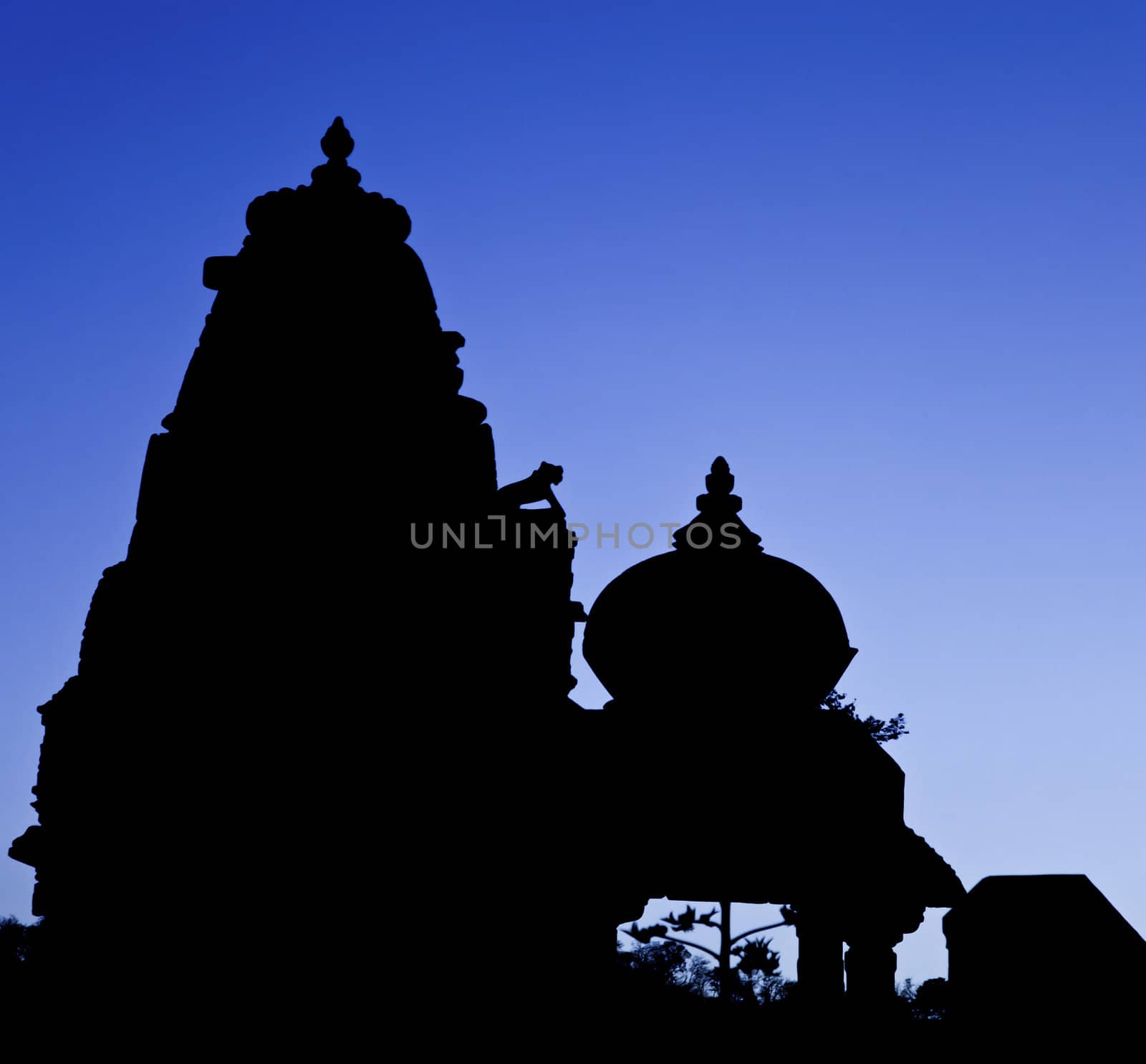 Rajasthan, India, silhouette of Jain and Hindu temples side by side as the night falls