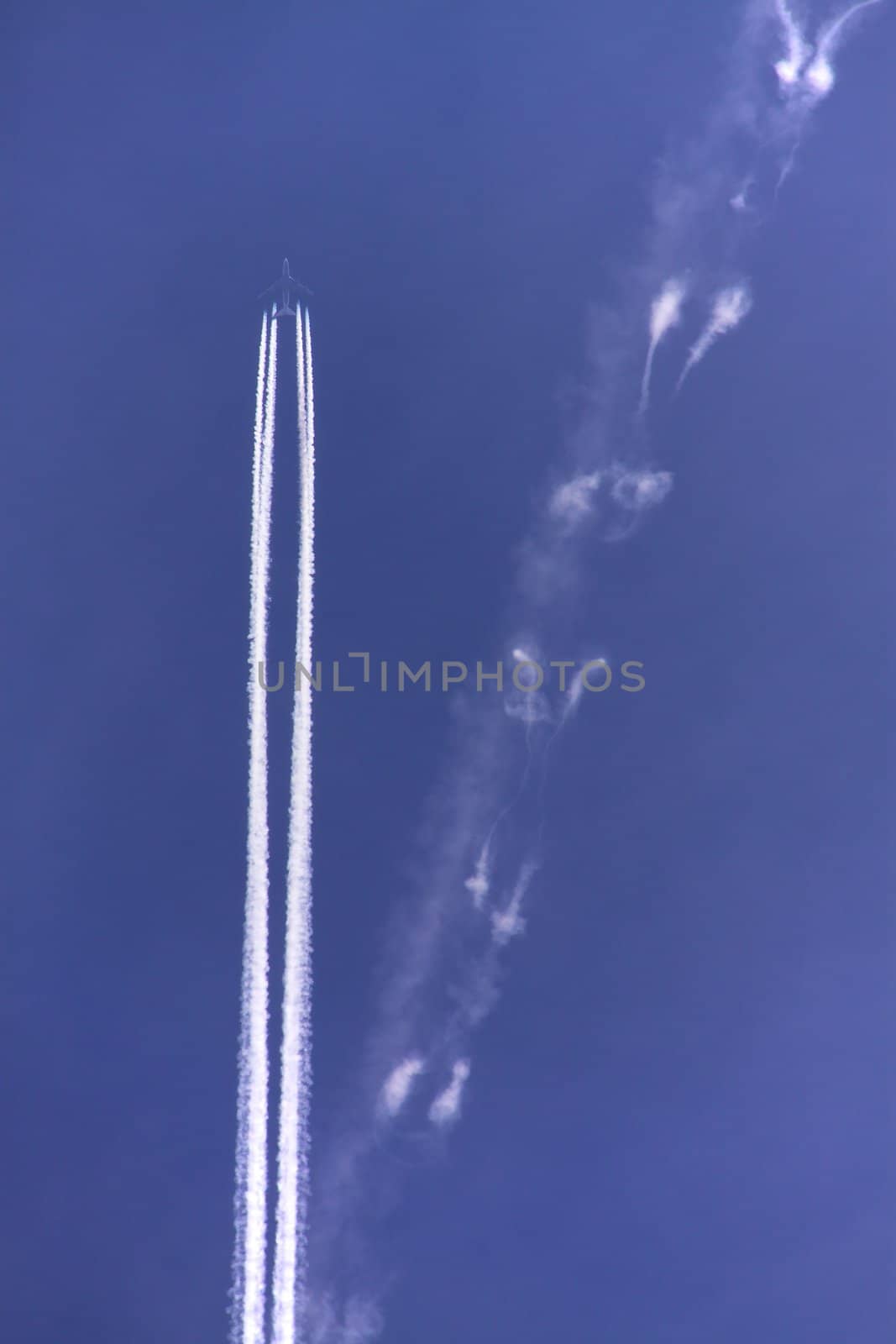 Condensation trail from a jet airplane with four engines