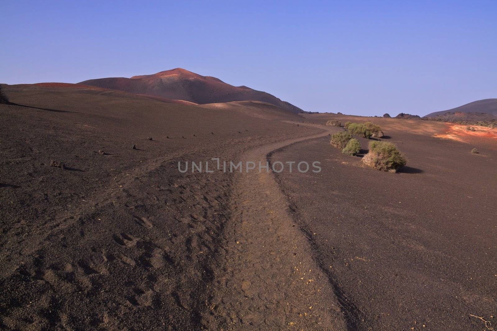 Trekking path in volcanic park Timanfaya on island of Lanzarote, Canary Islands