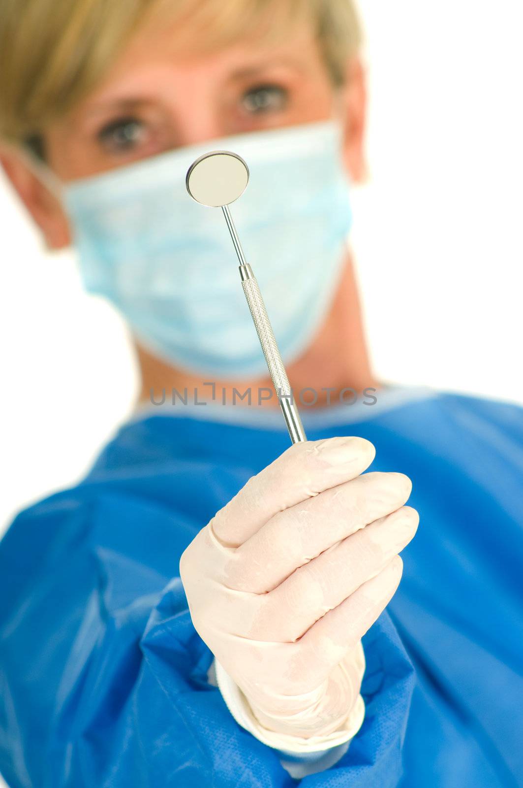 dentist holding dental mirror by ambro