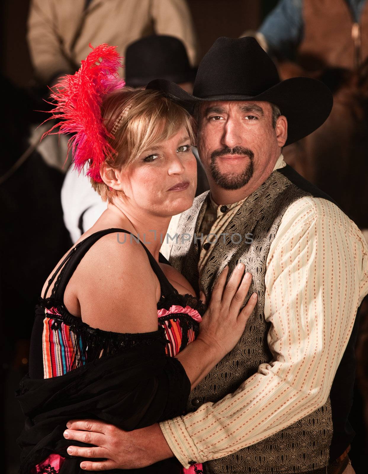 Handsome man and woman in old west costumes