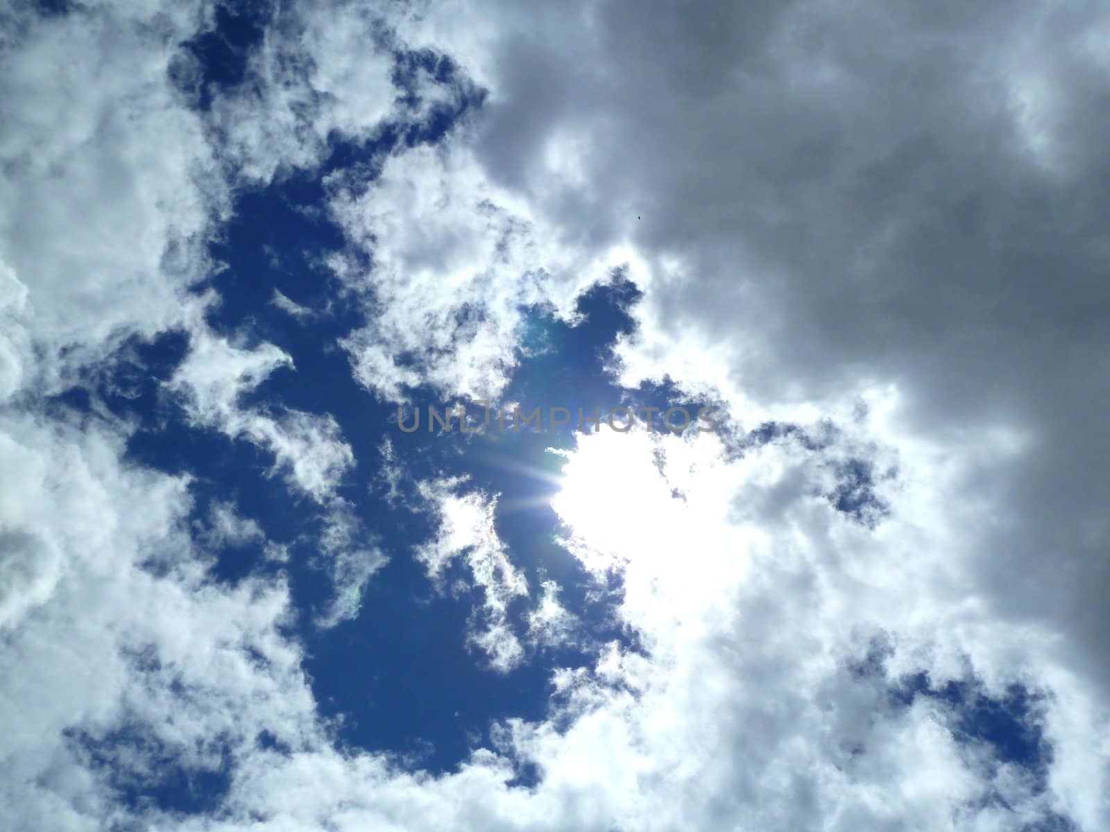 beautiful white clouds with bright sun as a background