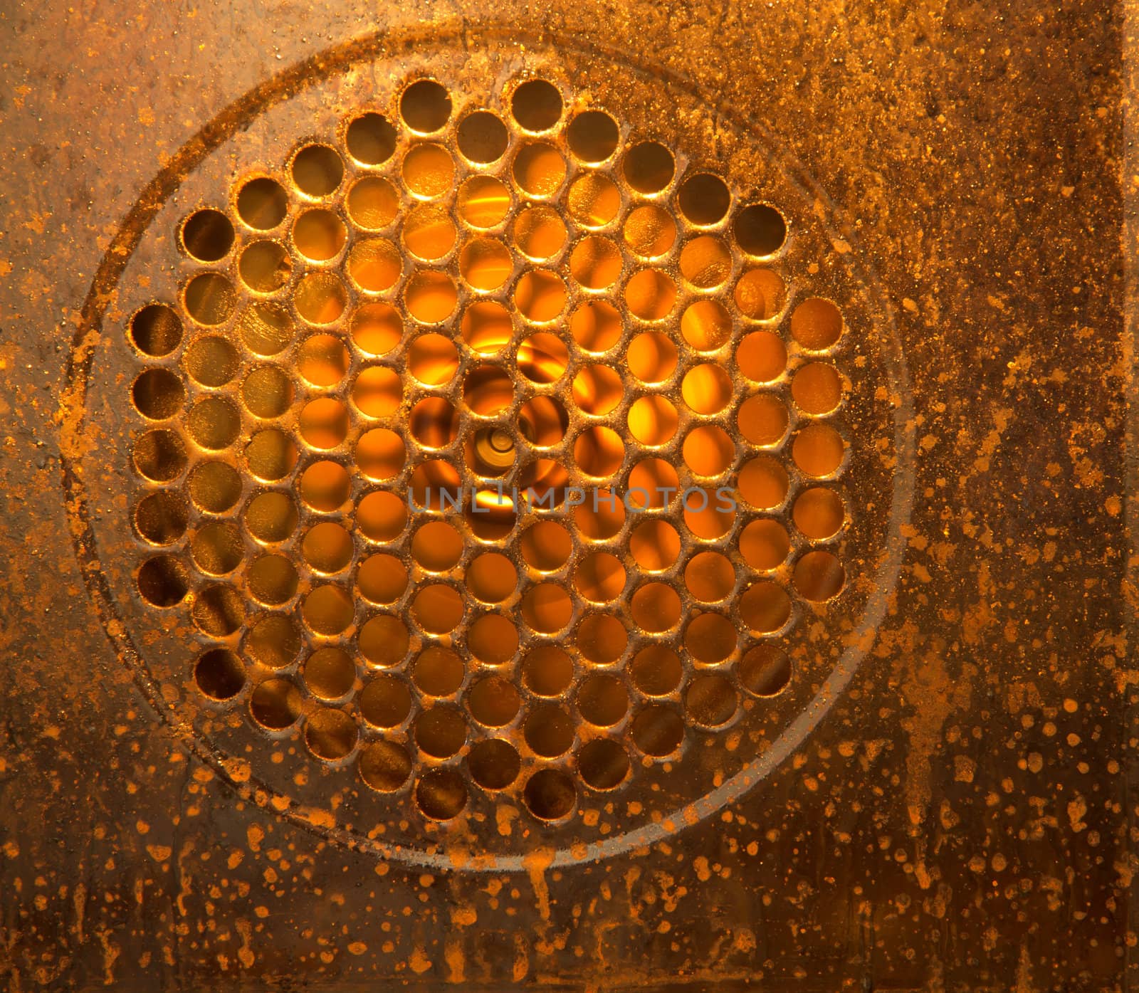 A picture of a running fan inside a dirty oven