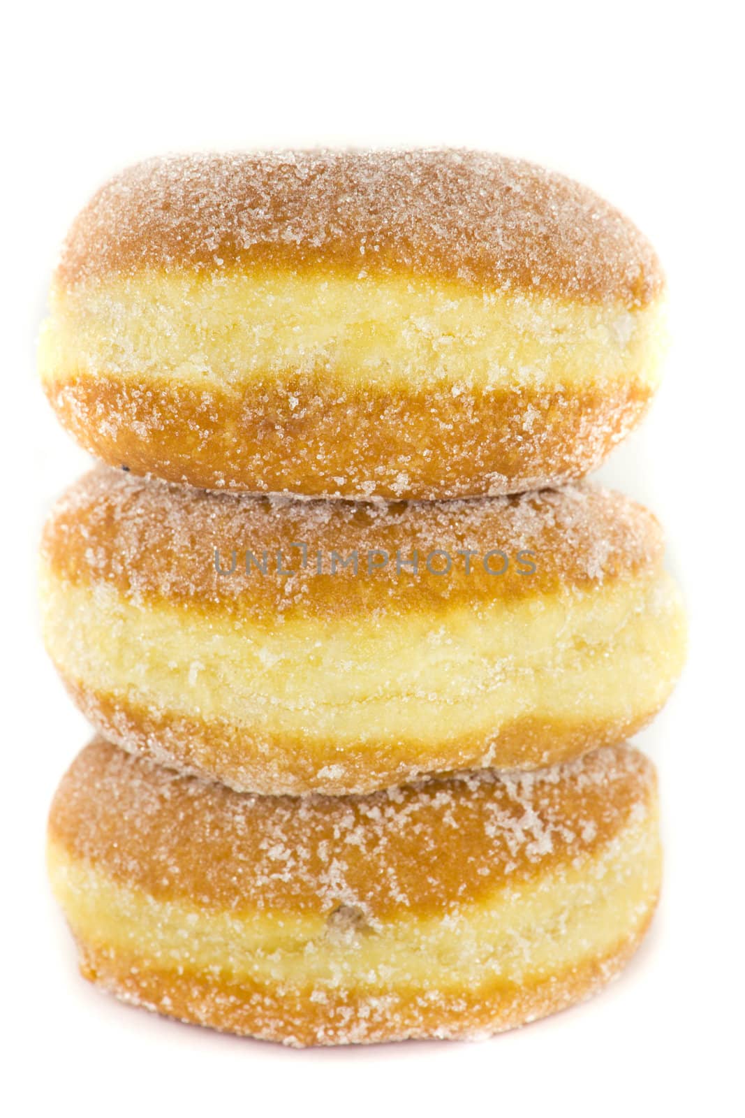 A picture of three jelly donuts stacked ontop of eachother