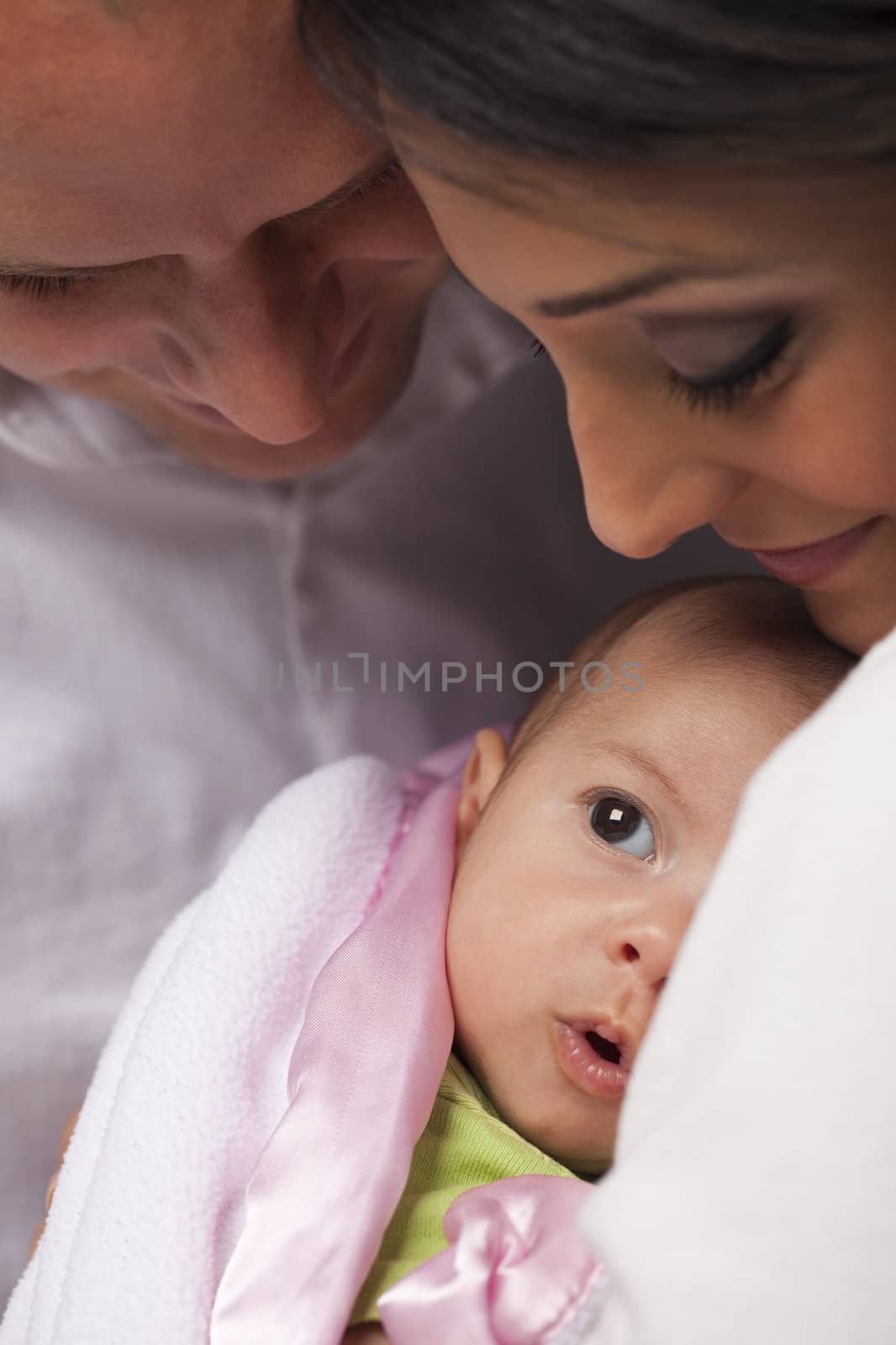 Happy Young Attractive Mixed Race Family with Newborn Baby.