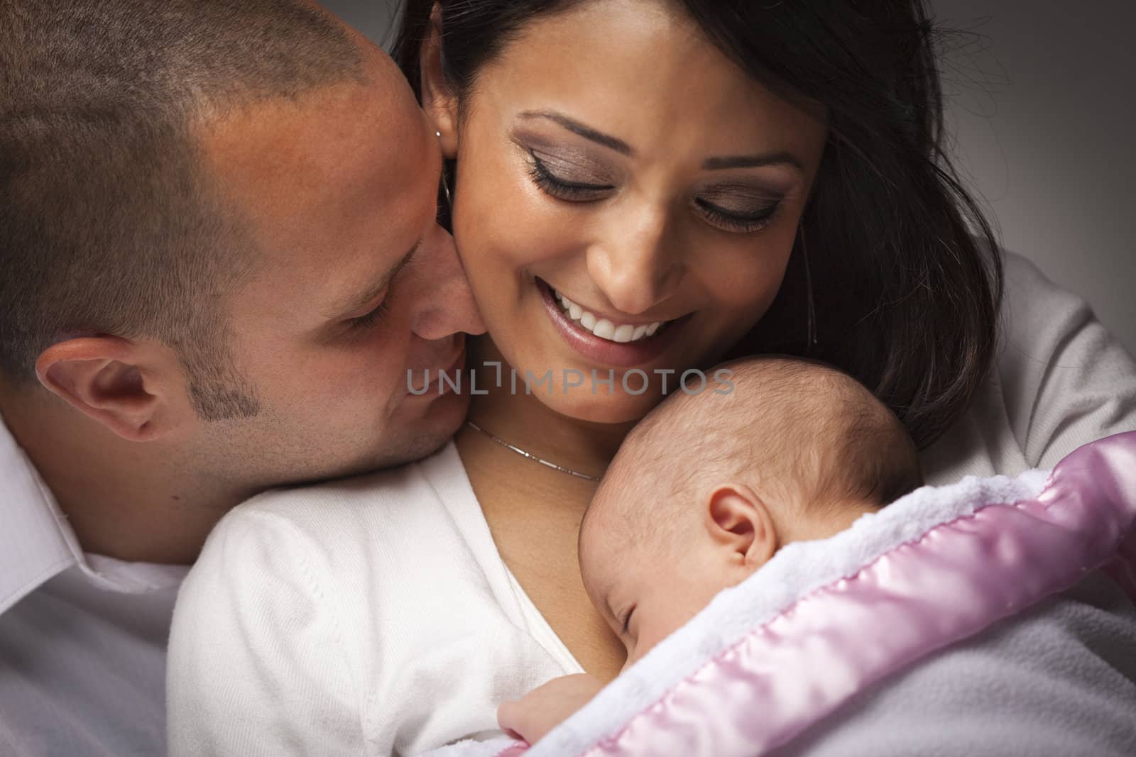 Happy Young Attractive Mixed Race Family with Newborn Baby.