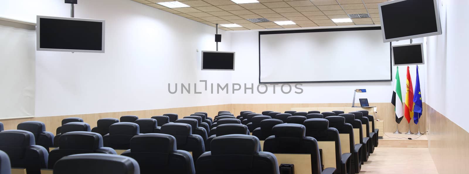 conference room equipped with modern screen monitors and armchairs