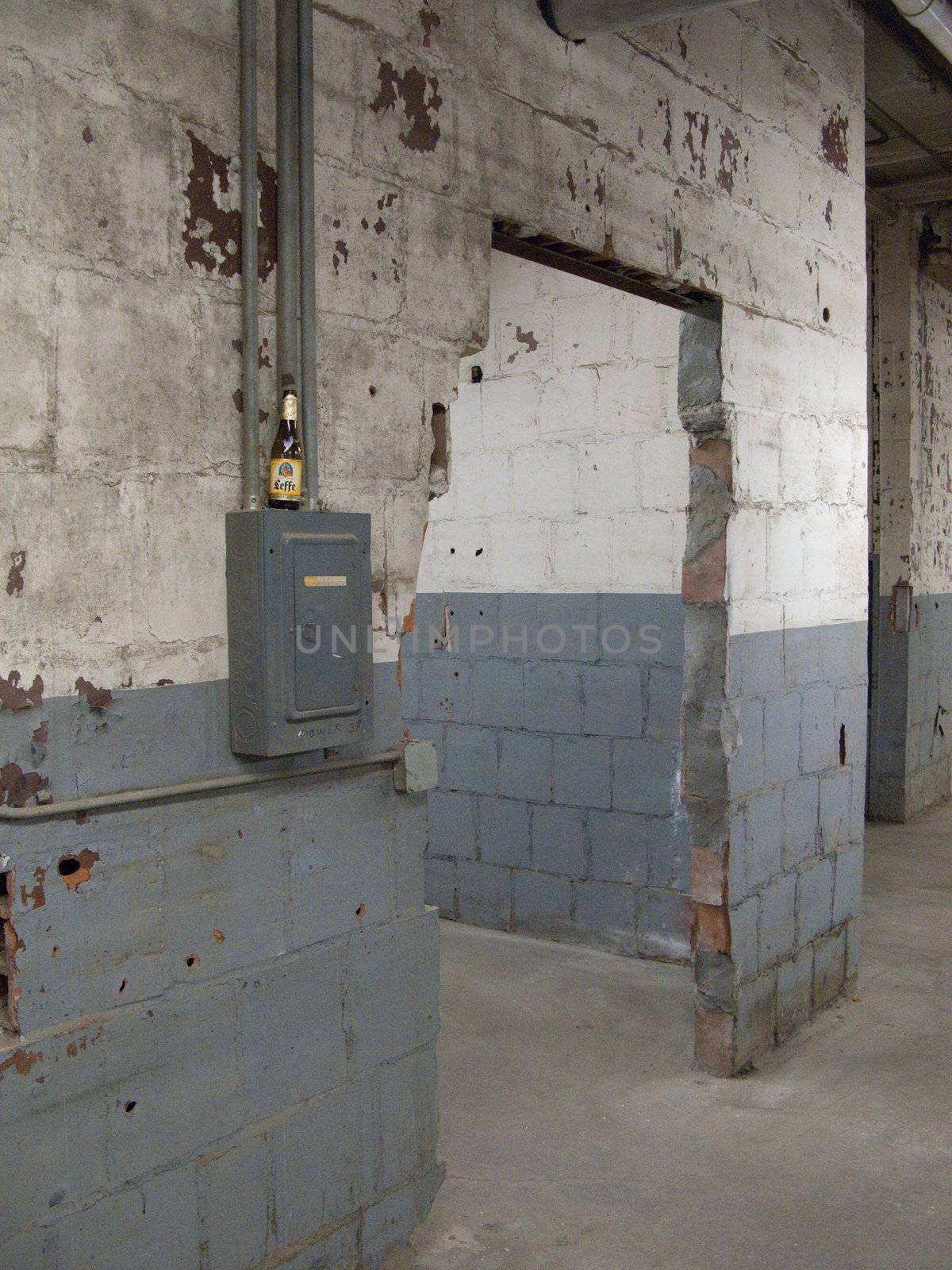Empty older warehouse / industrial space with grey  white walls