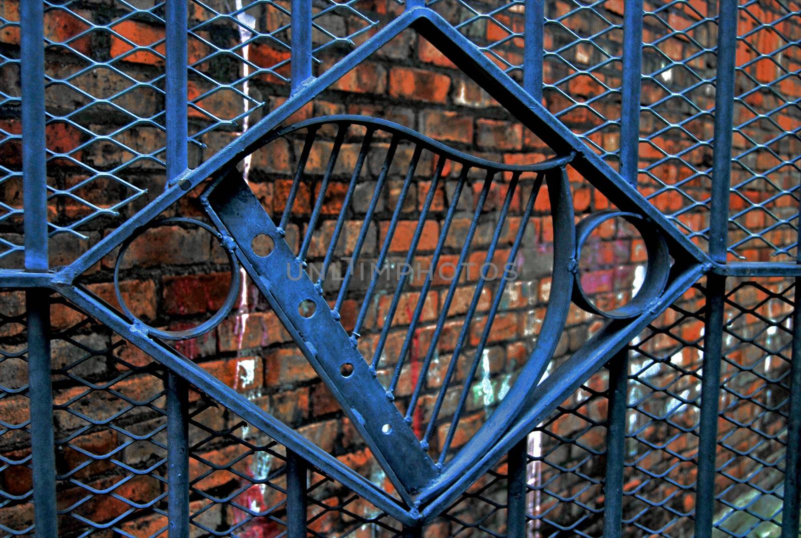 A harp on a gate guarding an alley in the Falls Road (Catholic) area of Belfast, Northern Ireland.