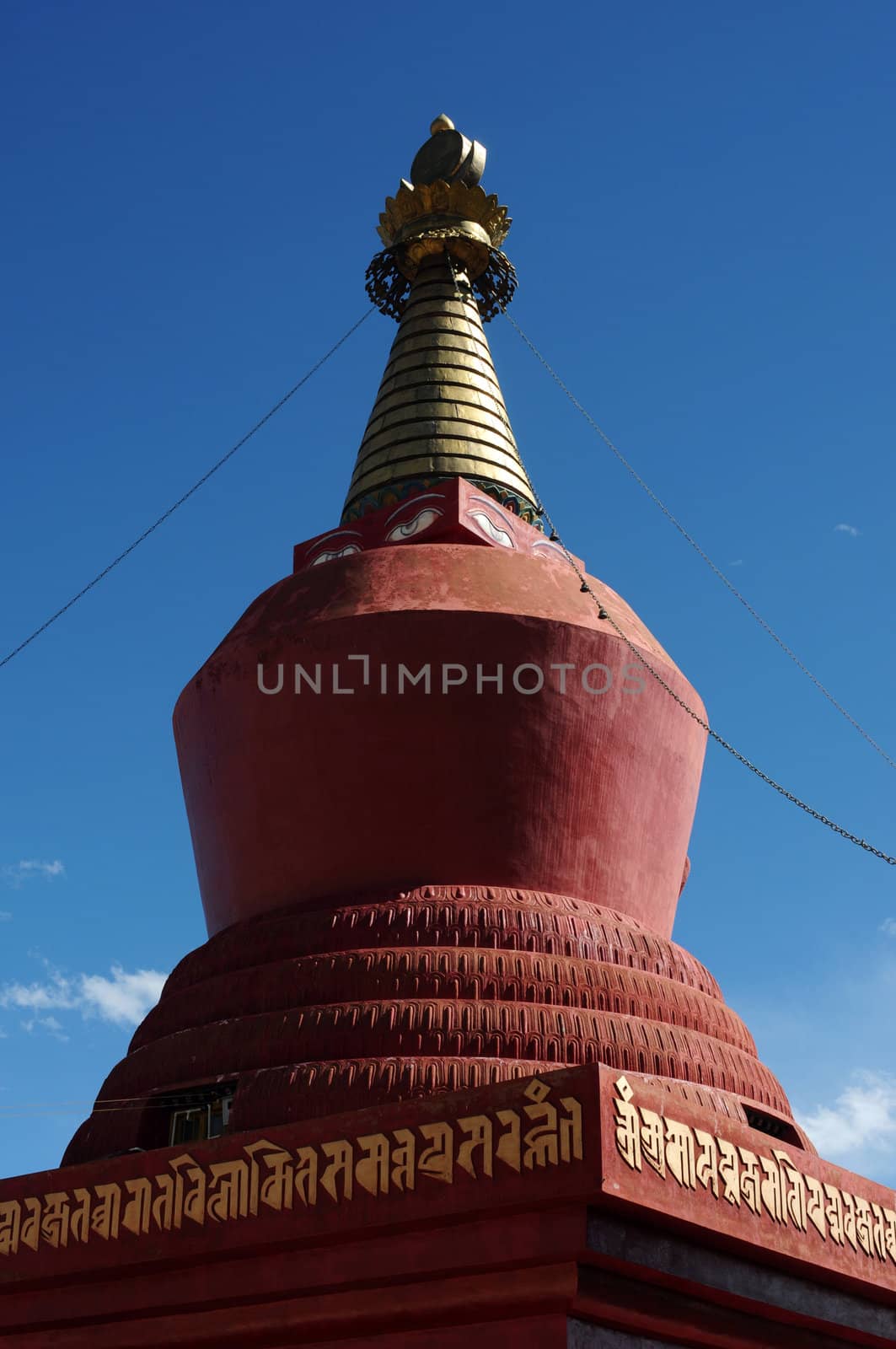 Landmark of a historic red stupa in Tibet against blue sky
