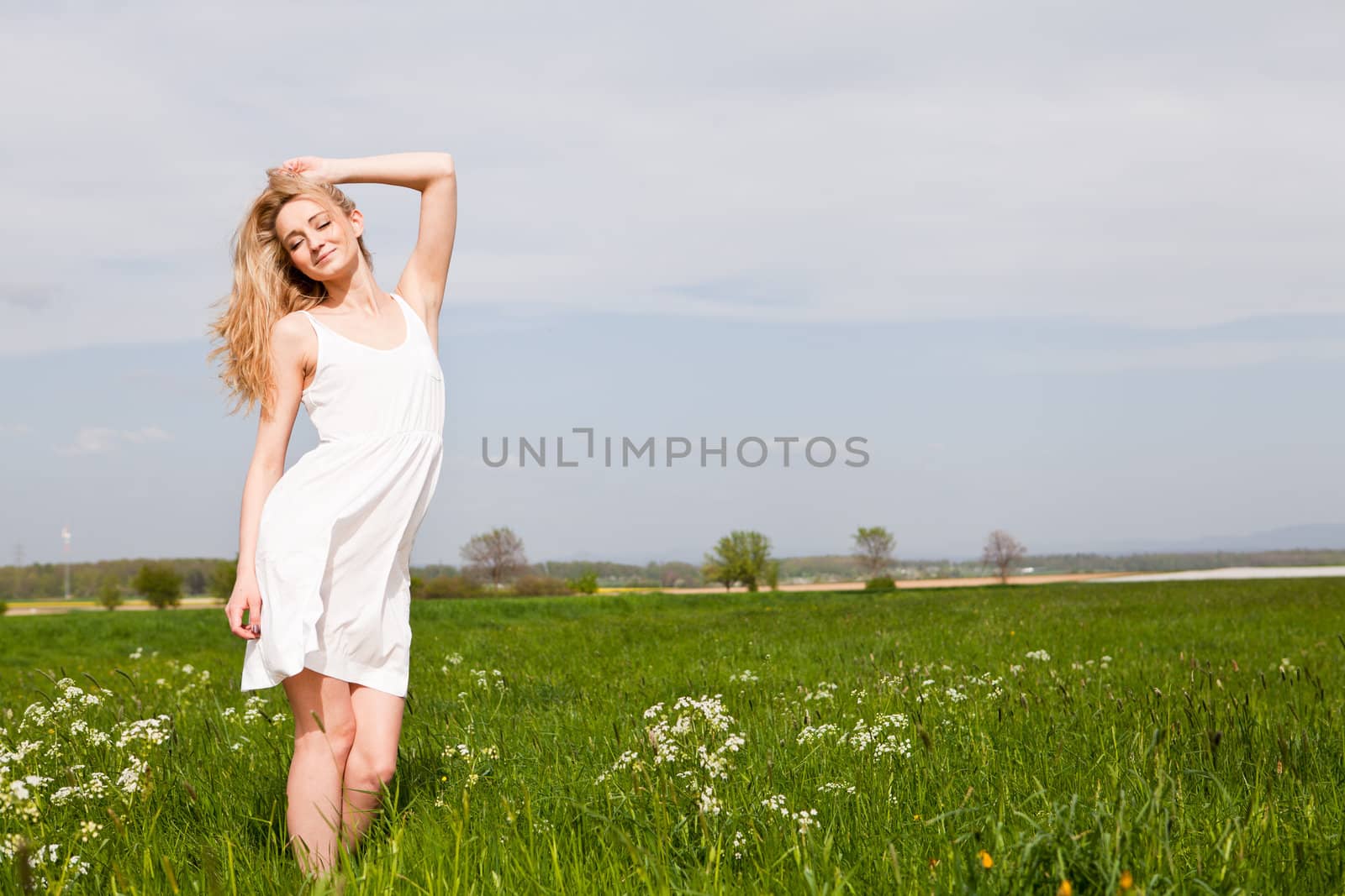 beautiful blonde woman outdoor in summer happy