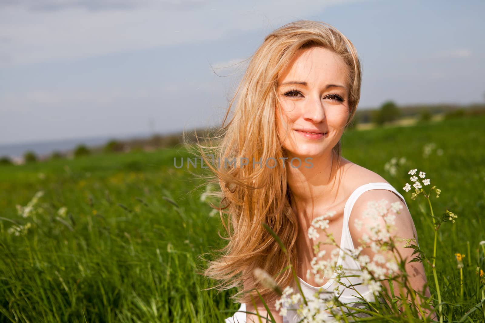 beautiful blonde woman outdoor in summer happy