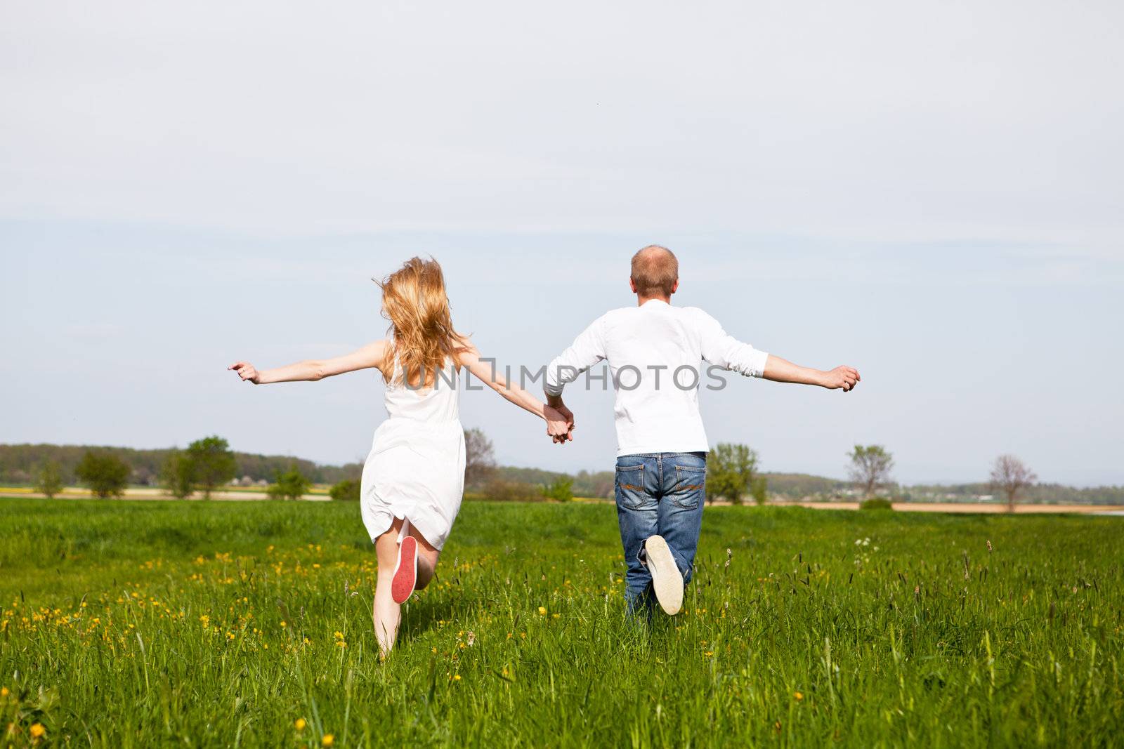 young happy couple have fun in summer outdoor in nature