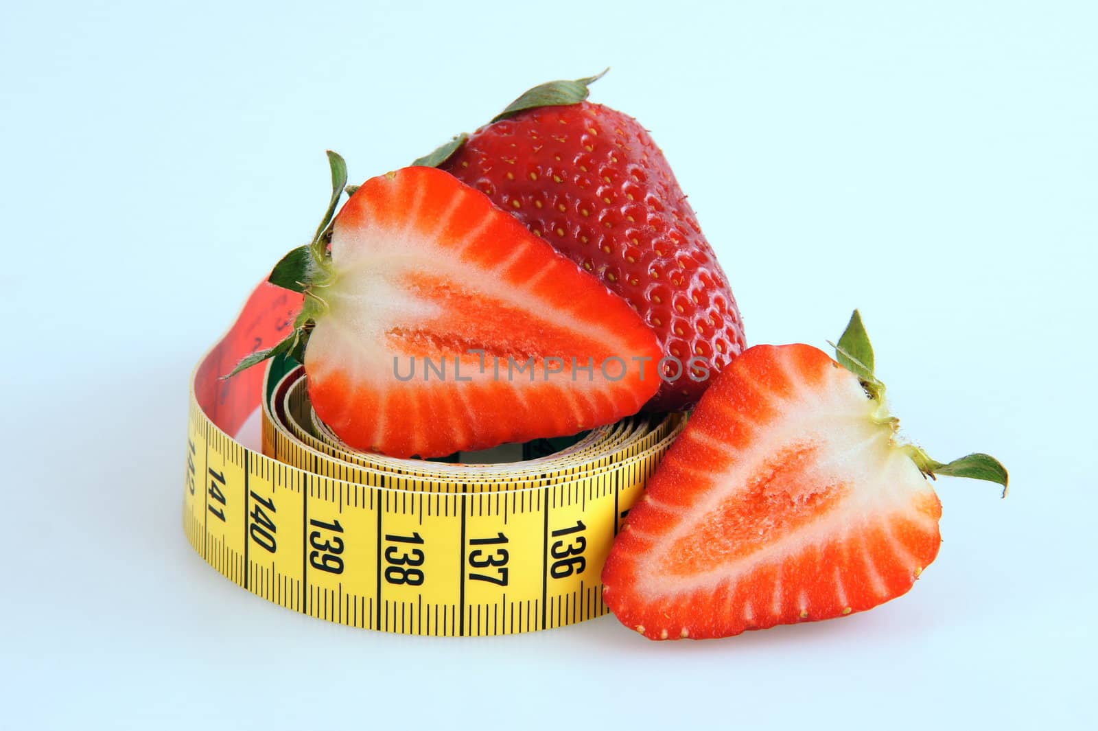 Fresh red tasty strawberries with measuring tape