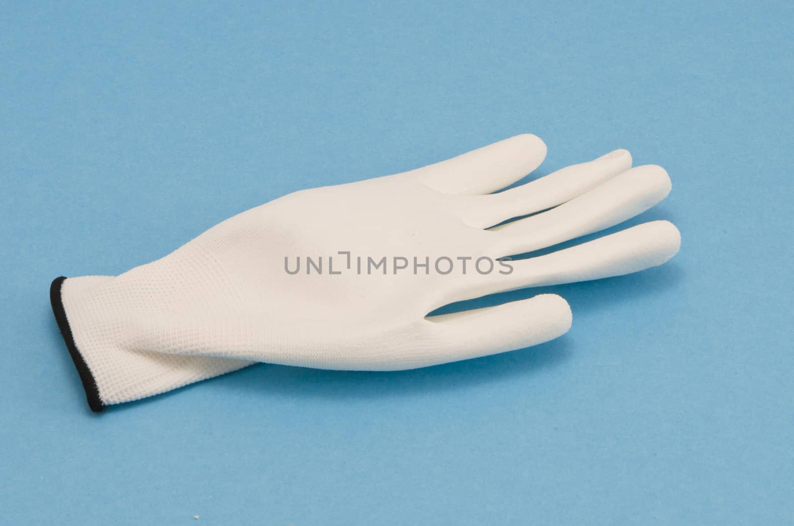 White working glove on blue background by sauletas