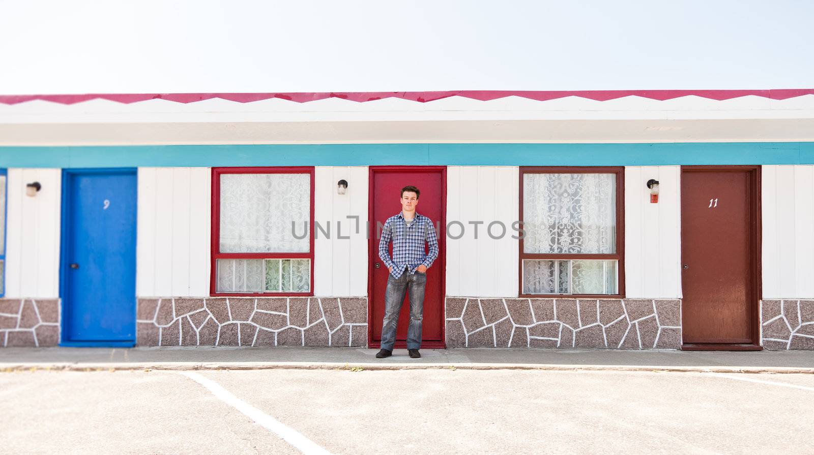 Young man in front of the red door by aetb