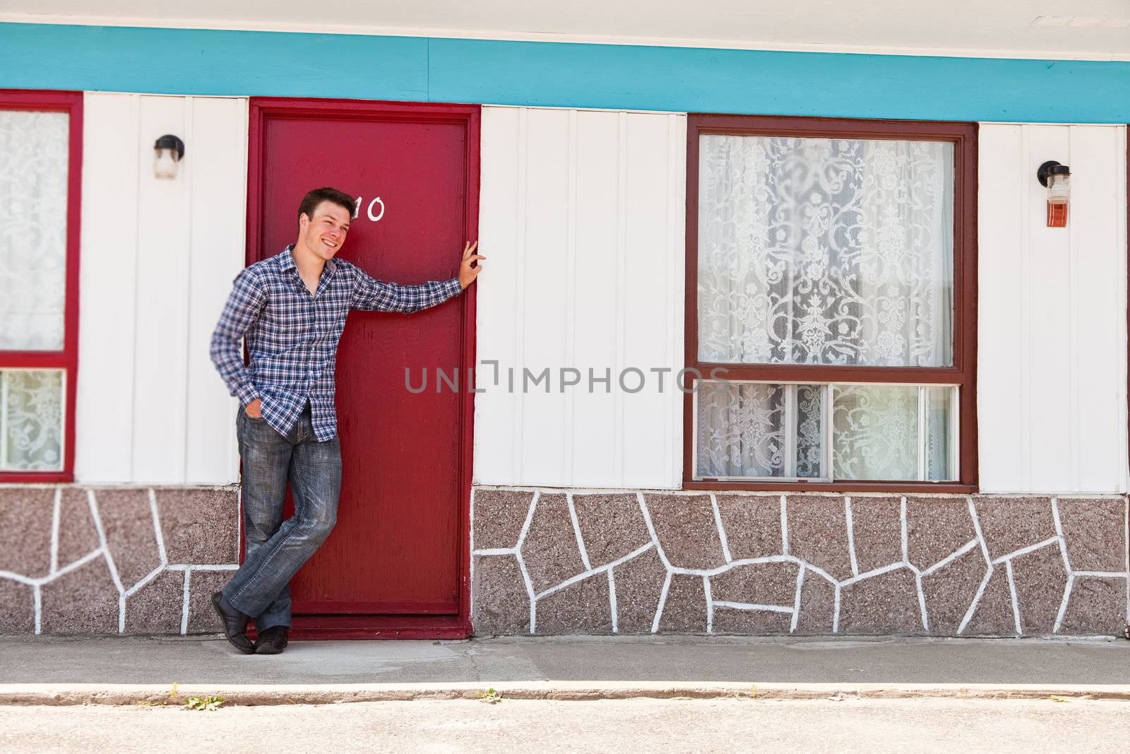 Young man looking for his ugly motel room