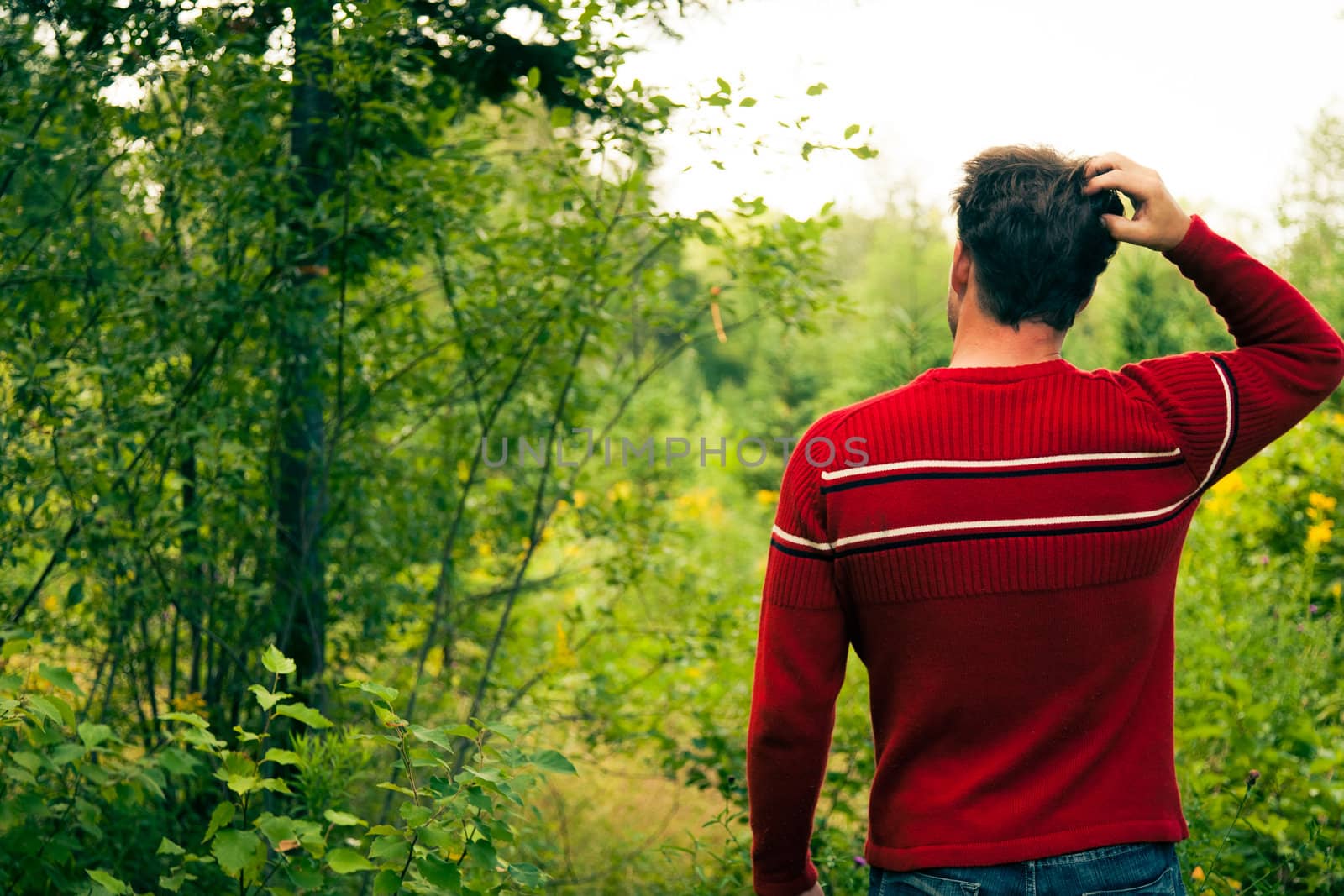 Lost Young man fonfused in the wild nature