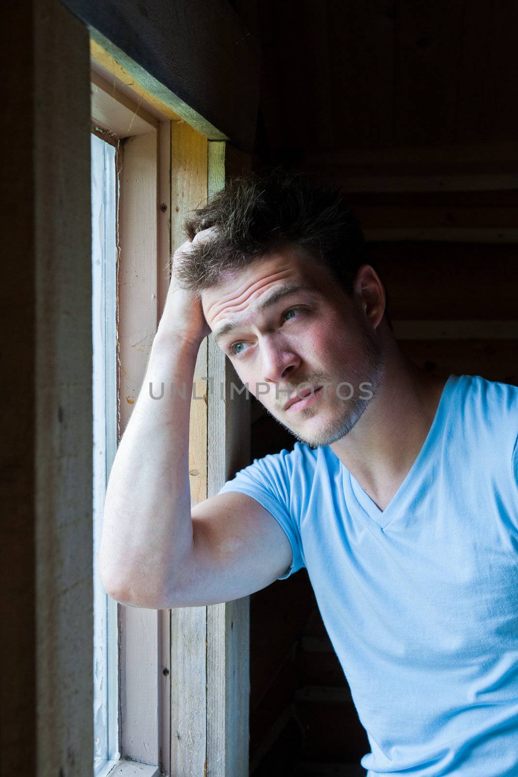 Young man tired and looking at the window