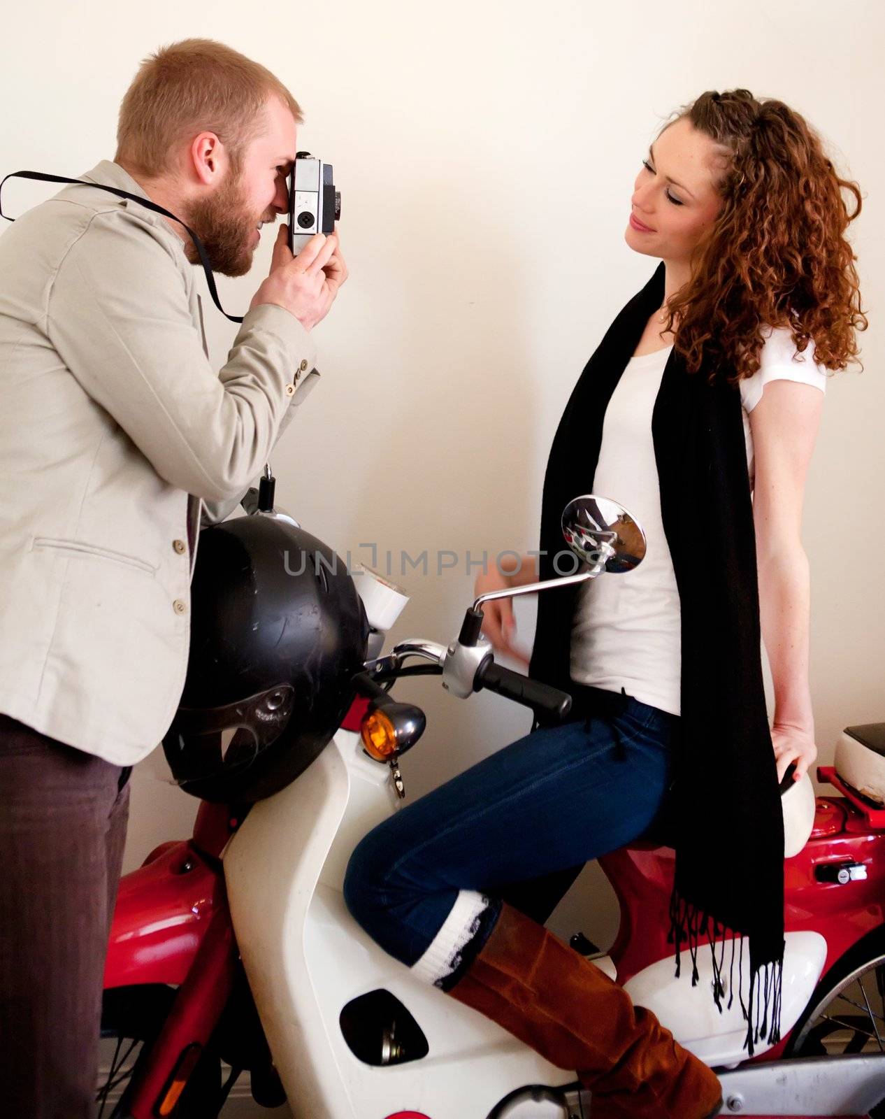 Photographer and a romantic model on the scooter.