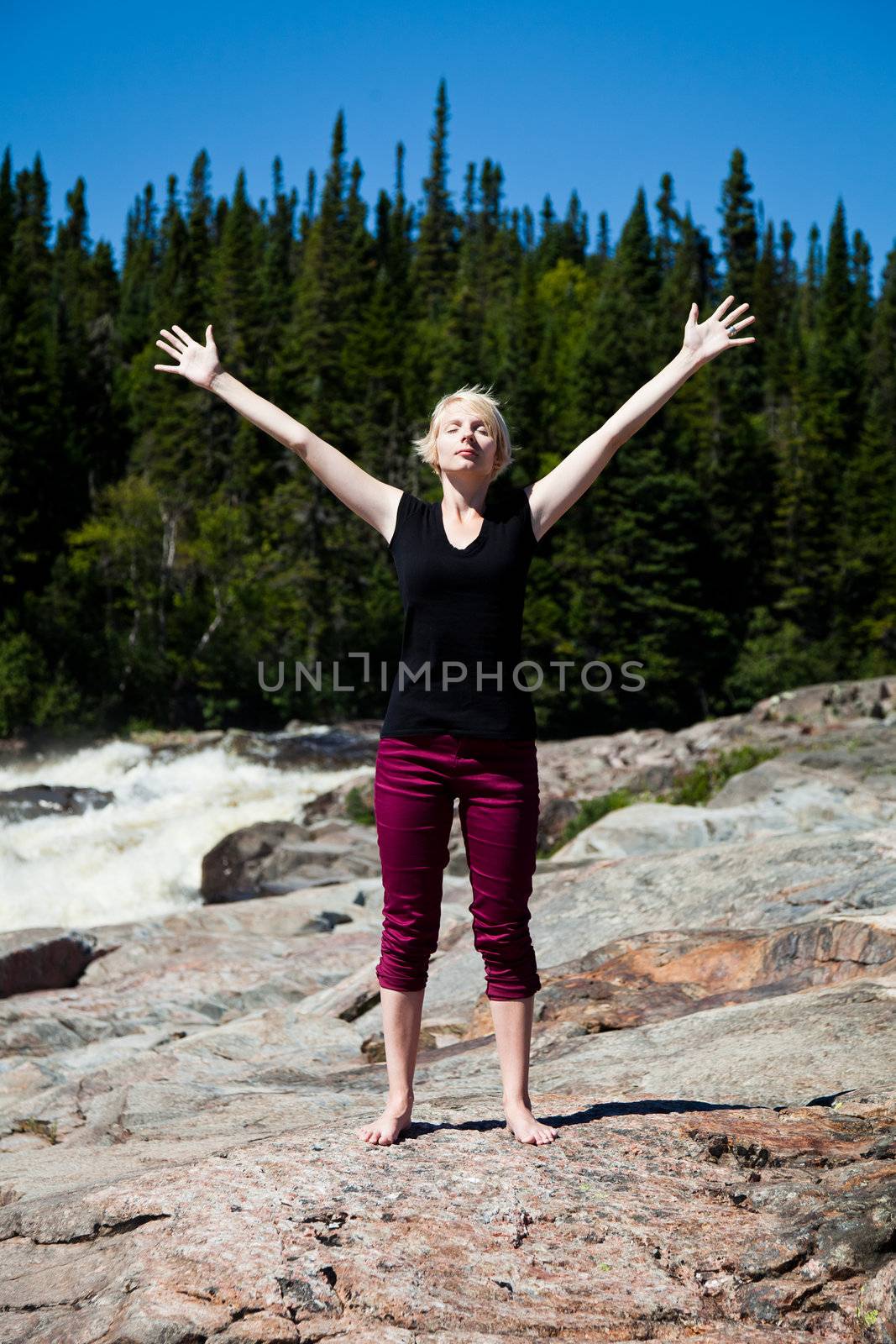 Young girl absorbing rays of sun - yoga
