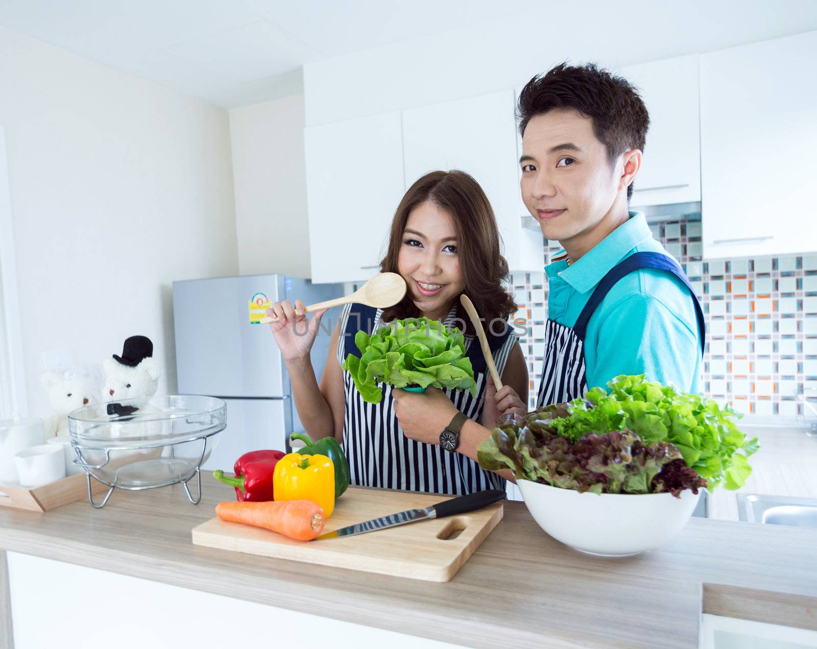 Young happy couples in domestic kitchen