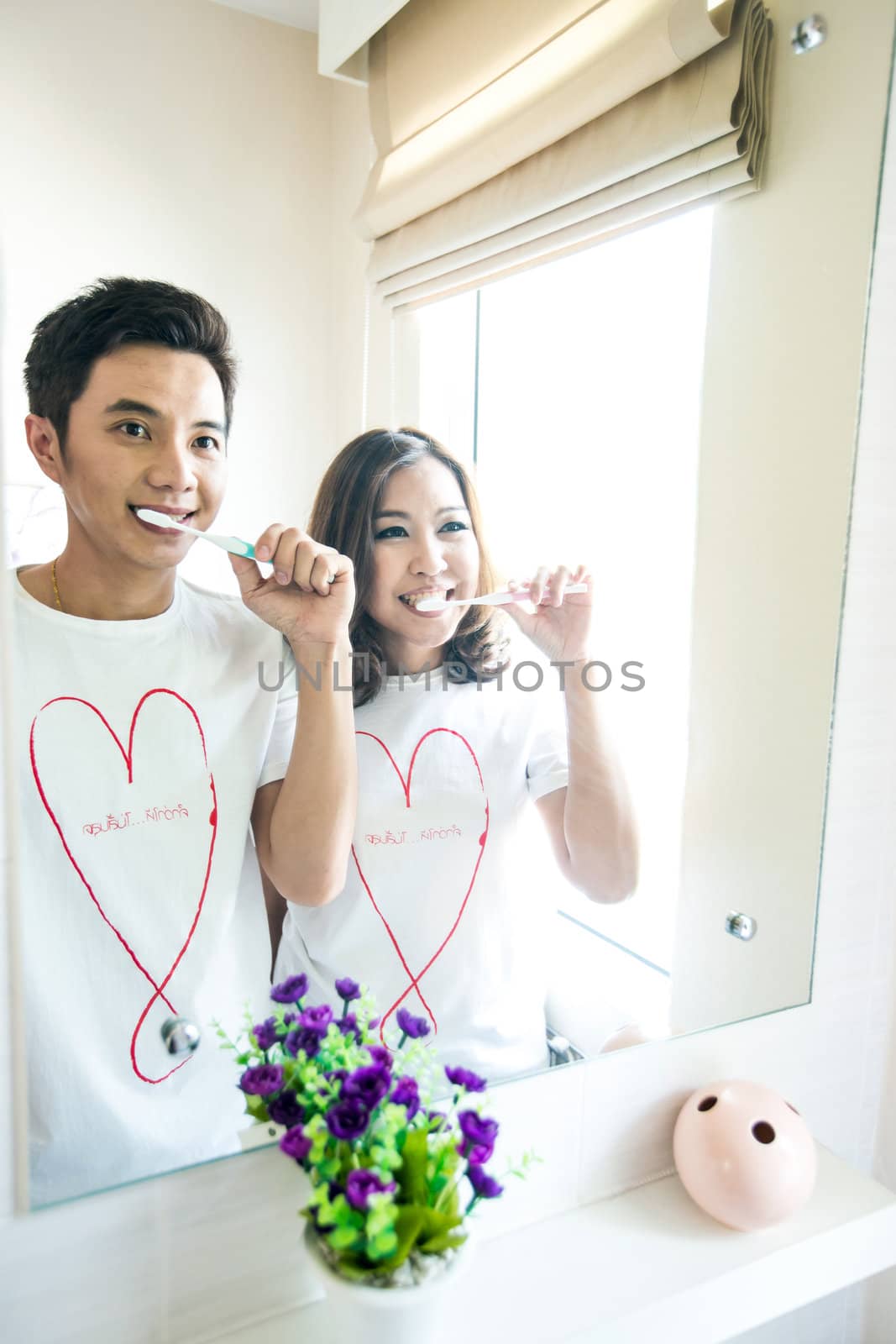 Happy smiling couple with toothbrushes
