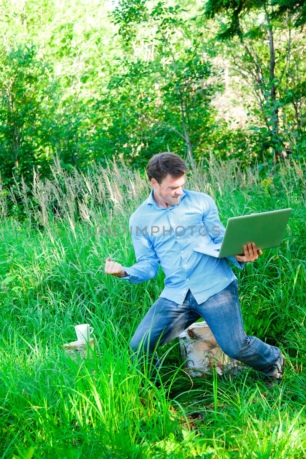 Super happy man in the forest with a laptop... it's a sucess !