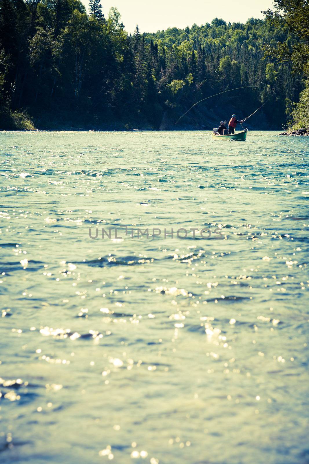 Fishermen fly fishing the salmon on a jolly-boat