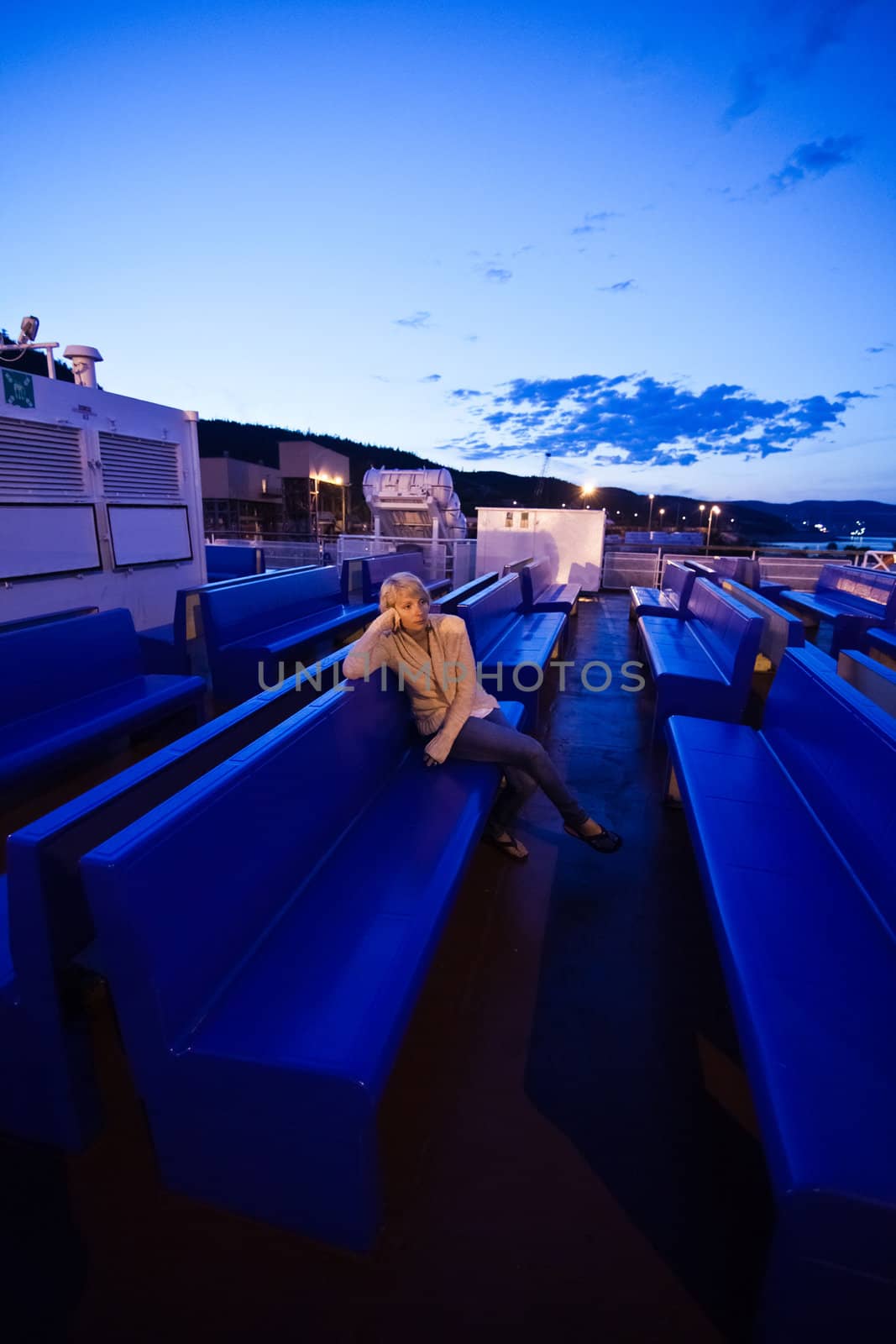 Girl sitting on the deck, the evening