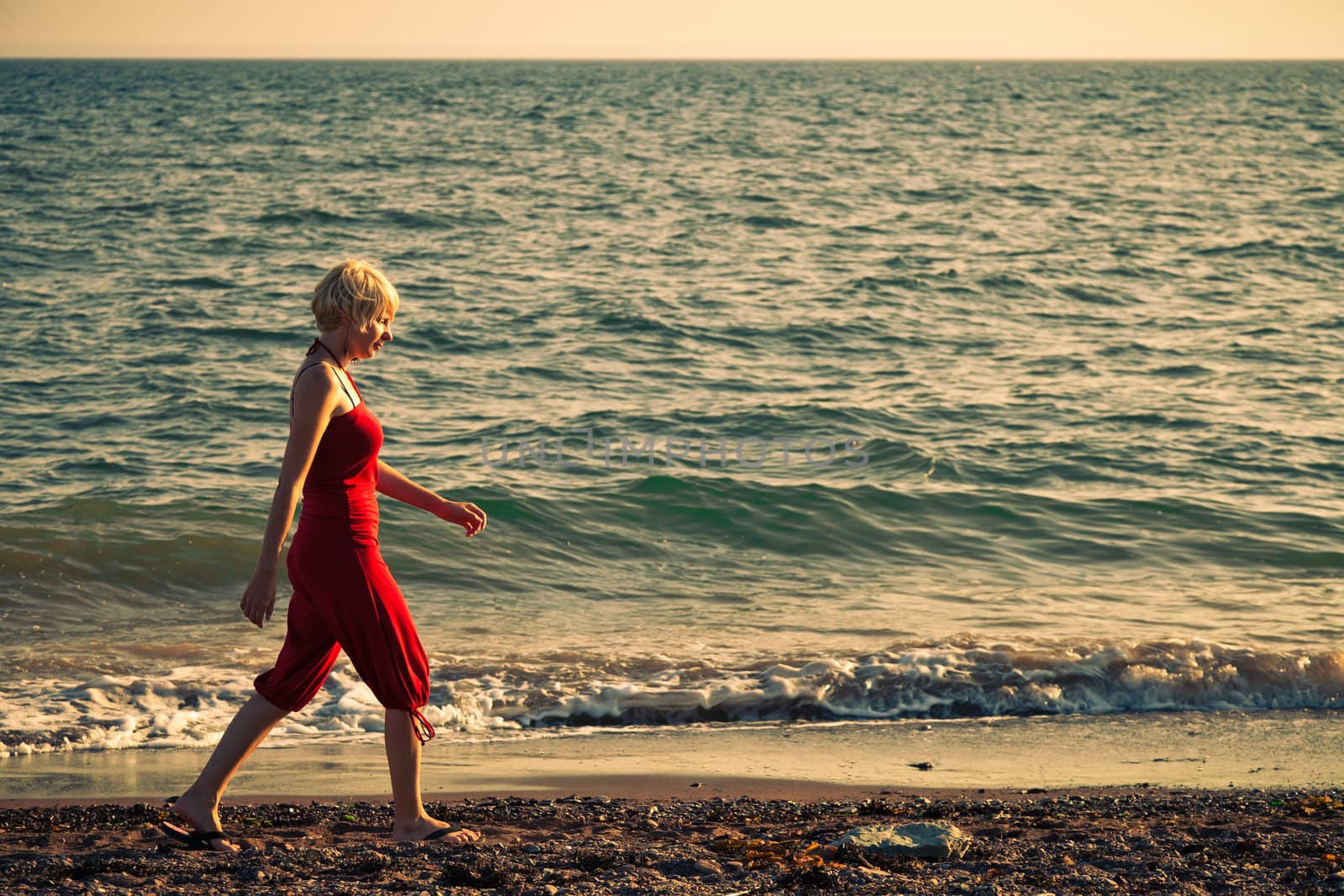 Girl walking along the beach - vintage look