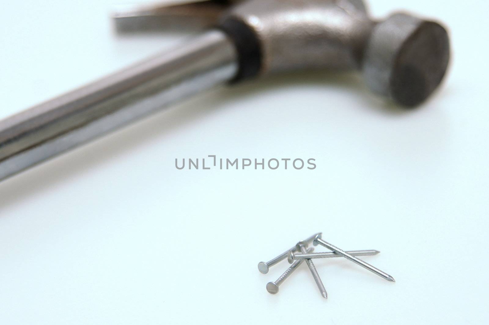 Nails with a hammer in the background. shallow depth of field.