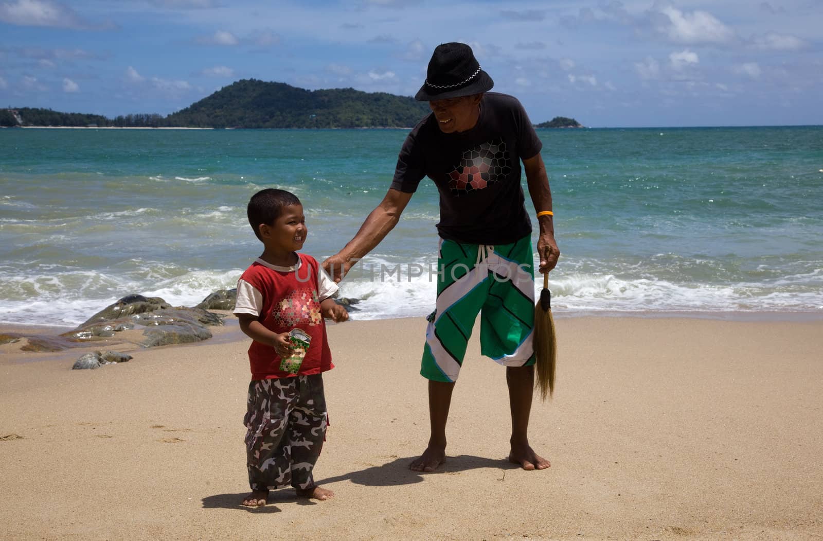 Thailand, Phuket, Patong, Indigenous people: my grandfather with his grandson on the beach