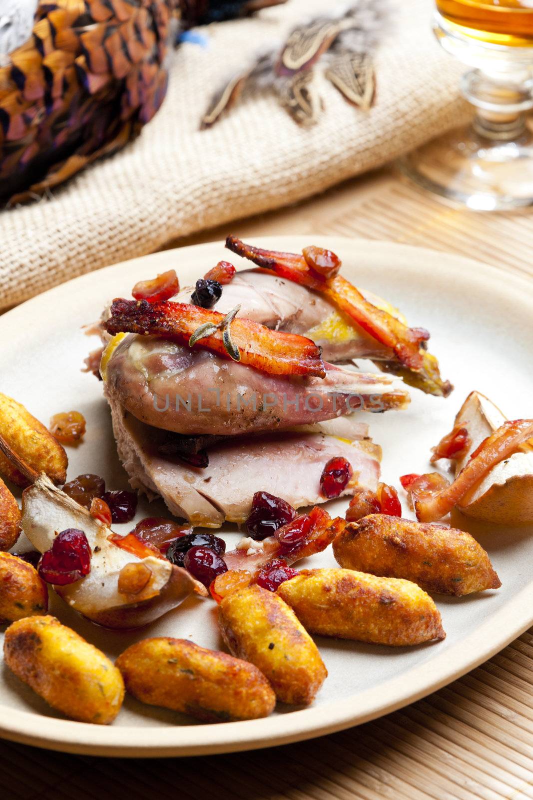 baked pheasant with bacon, pear, raisins on brandy