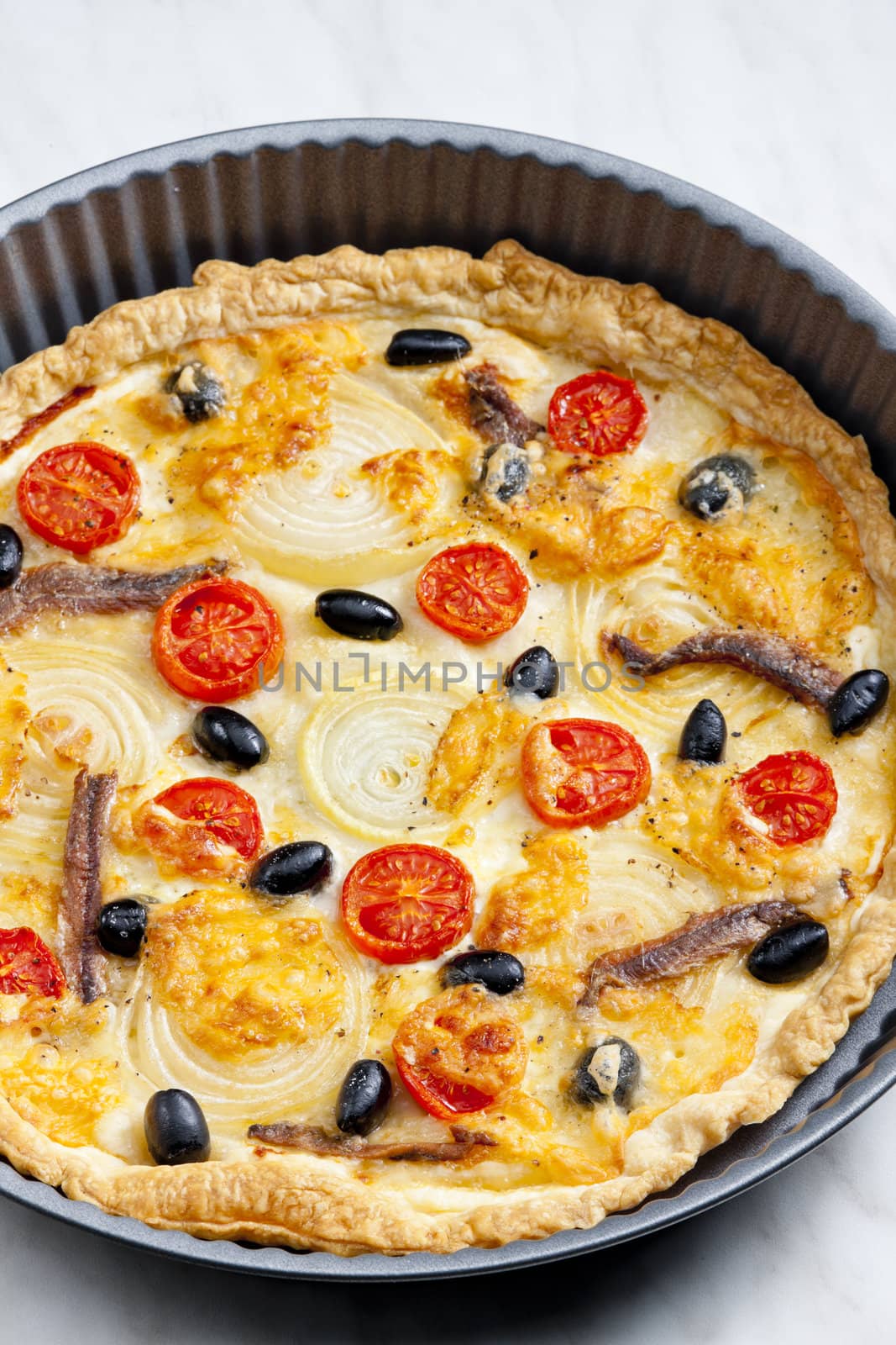 cake with anchovies, cherry tomatoes and black olives