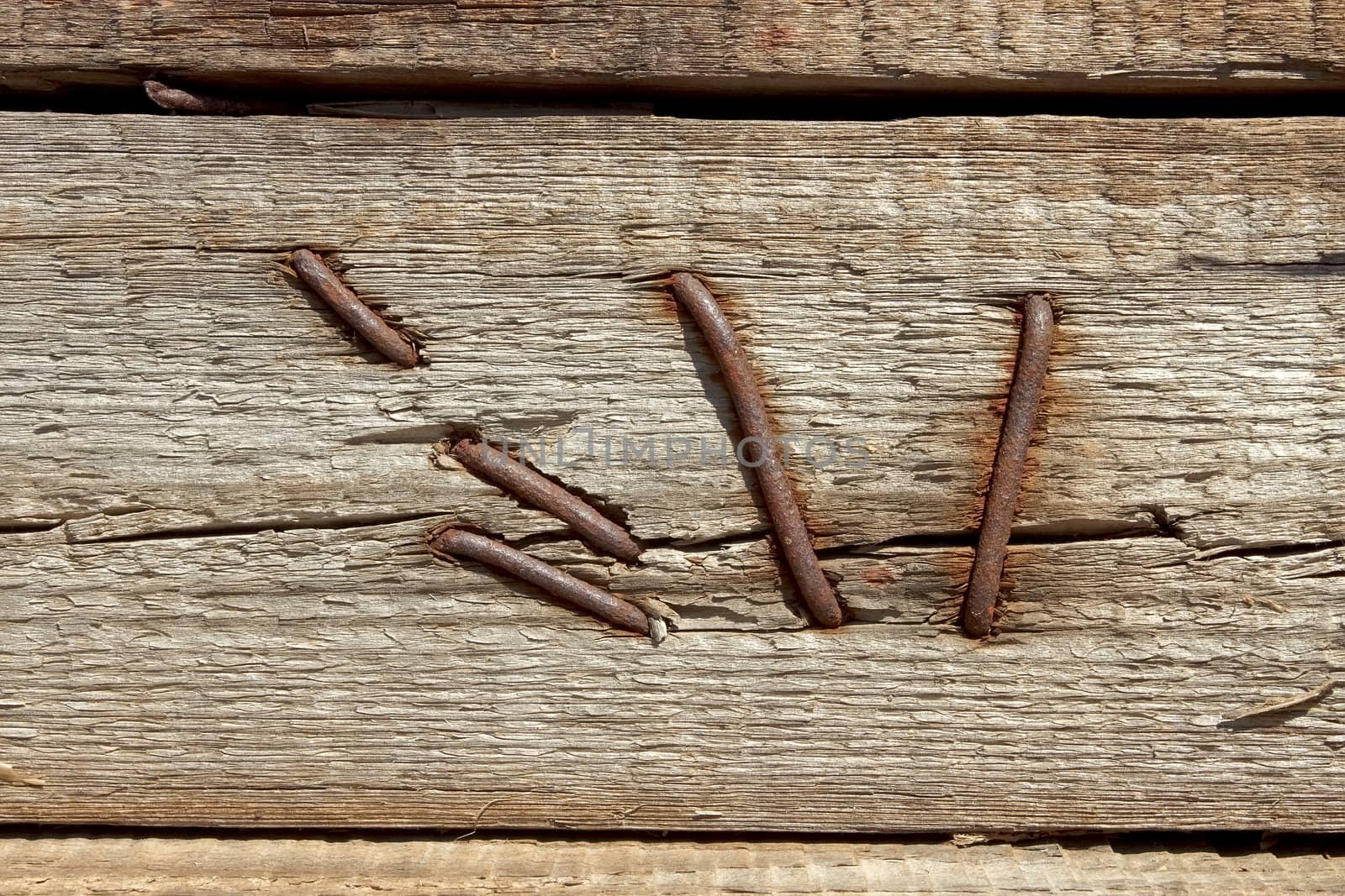 Fragment of old wooden slats fasten with rusty nails 