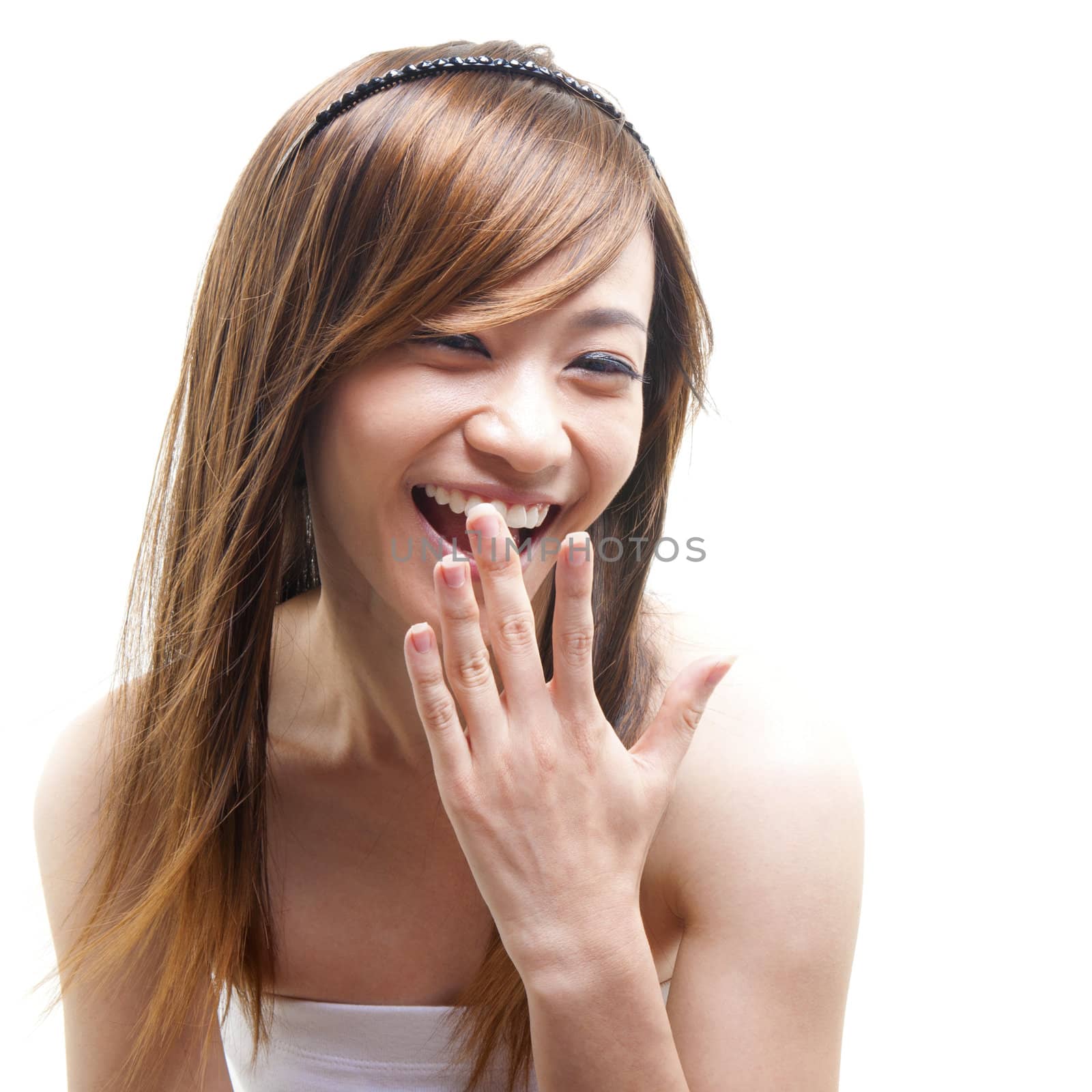 Laughing Asian woman covering her mouth on white background