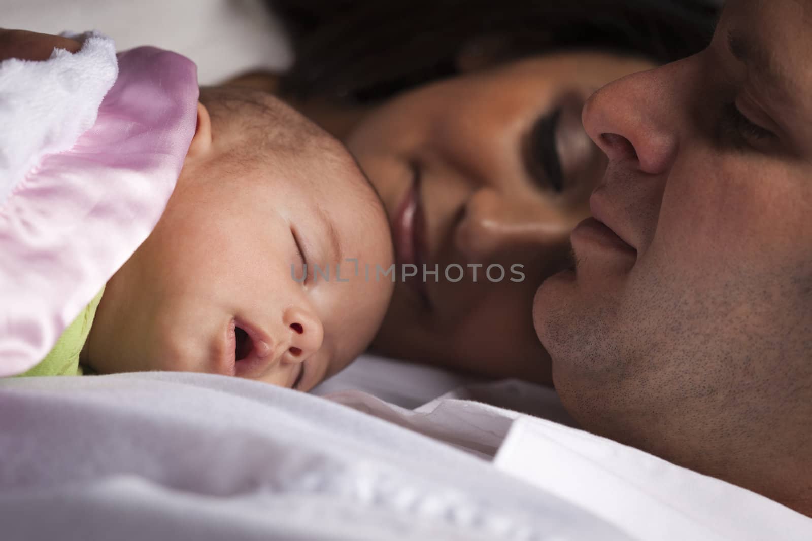 Happy Young Attractive Mixed Race Family with Newborn Baby.