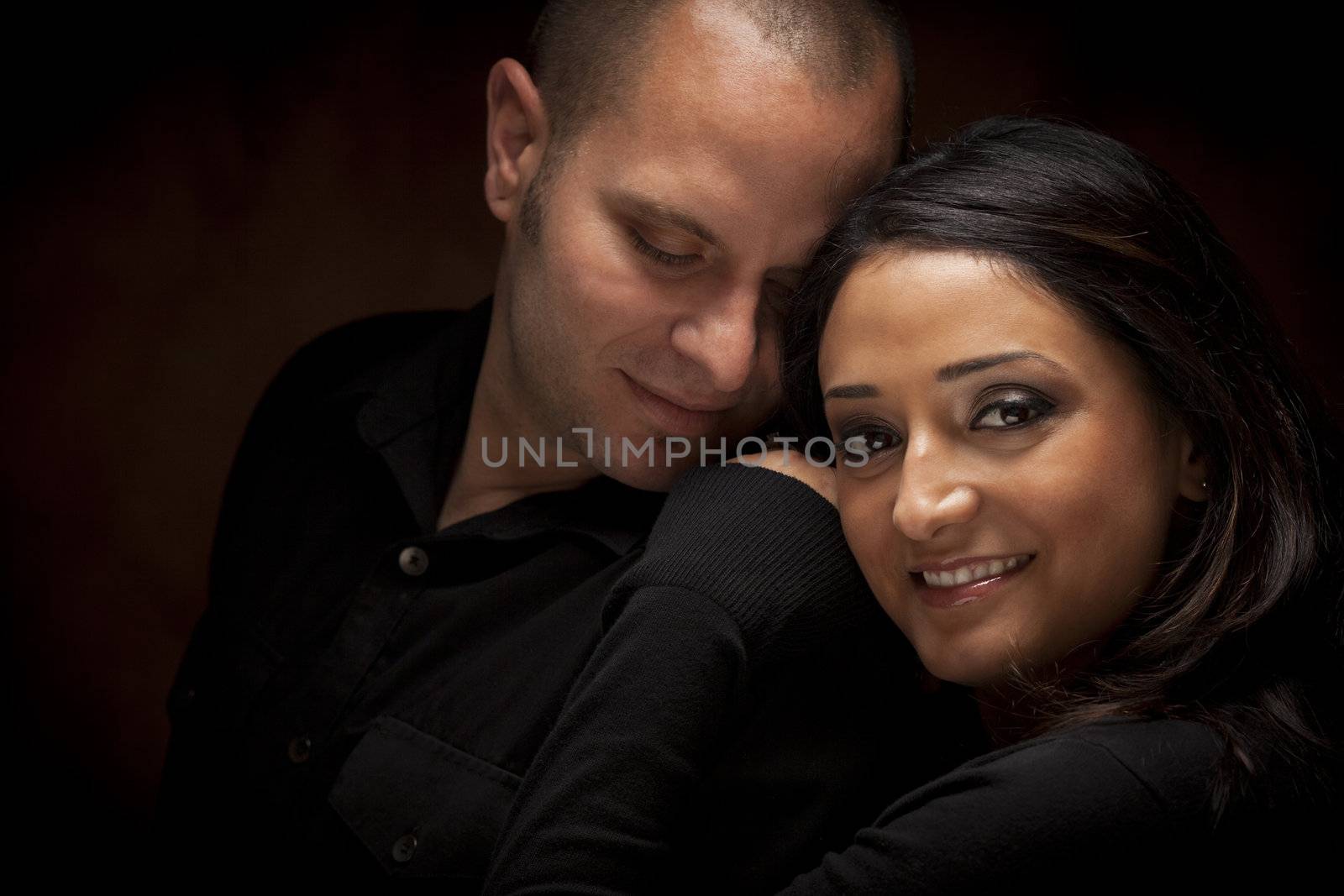 Happy Mixed Race Couple Flirting with Each Other Portrait Against A Black Background.