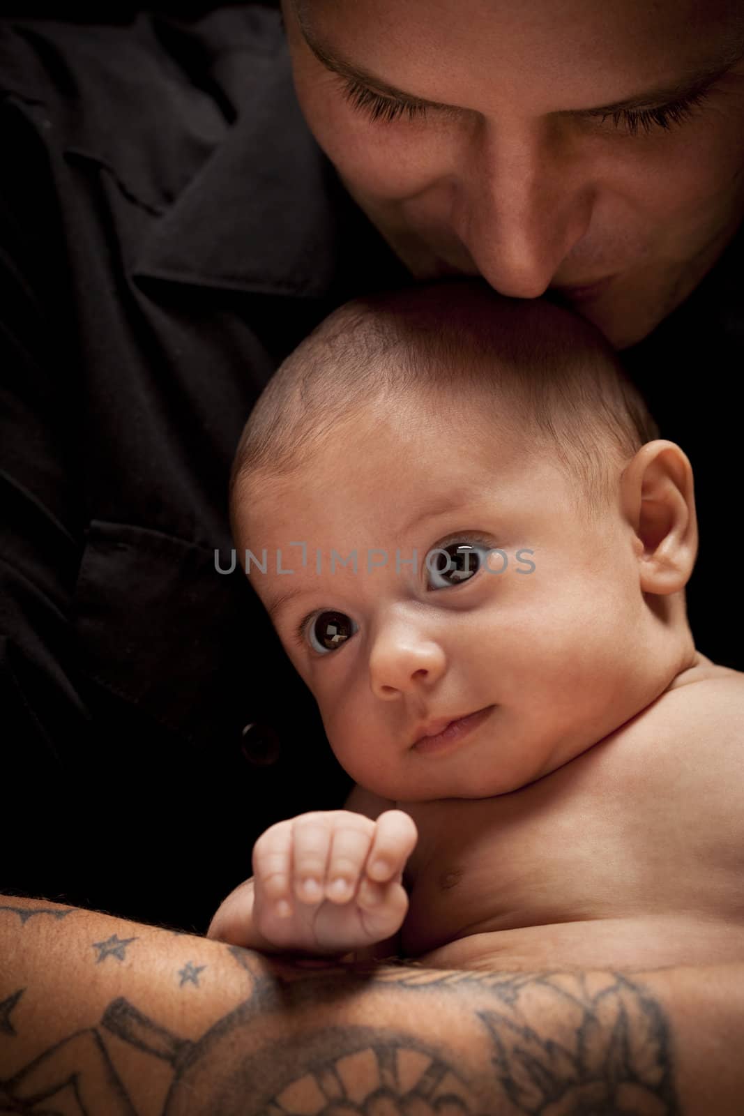 Young Father Holding His Mixed Race Newborn Baby by Feverpitched
