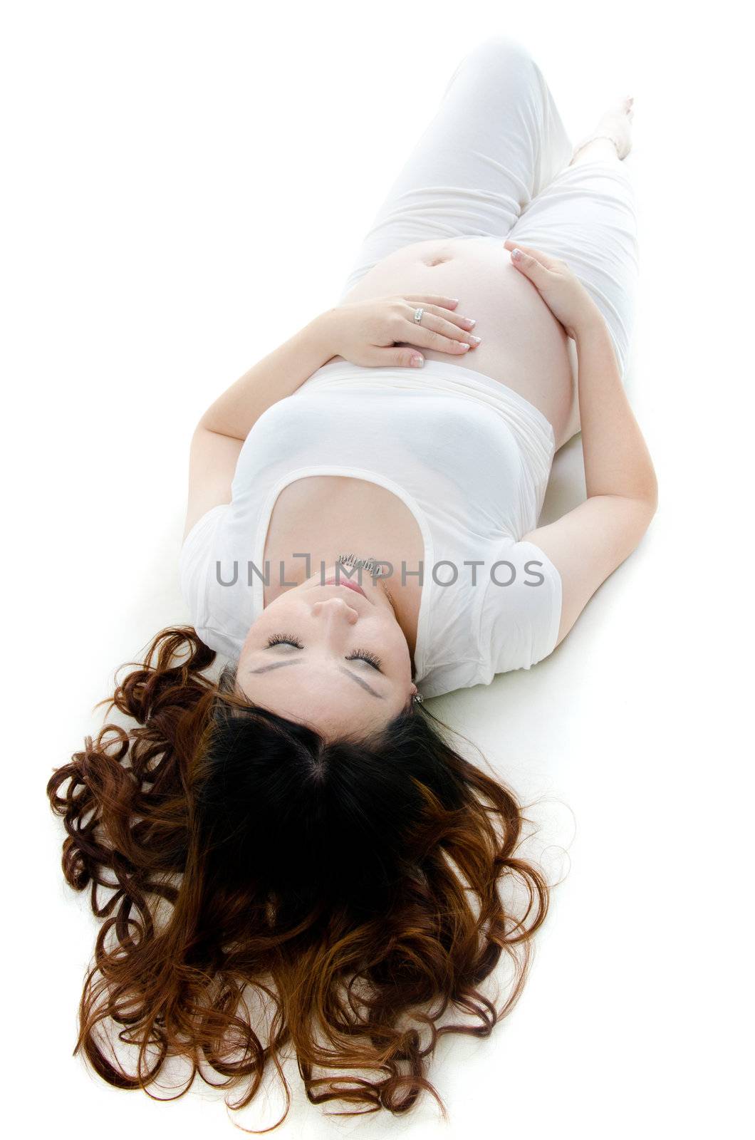 Pan Asian pregnant lady lying on floor