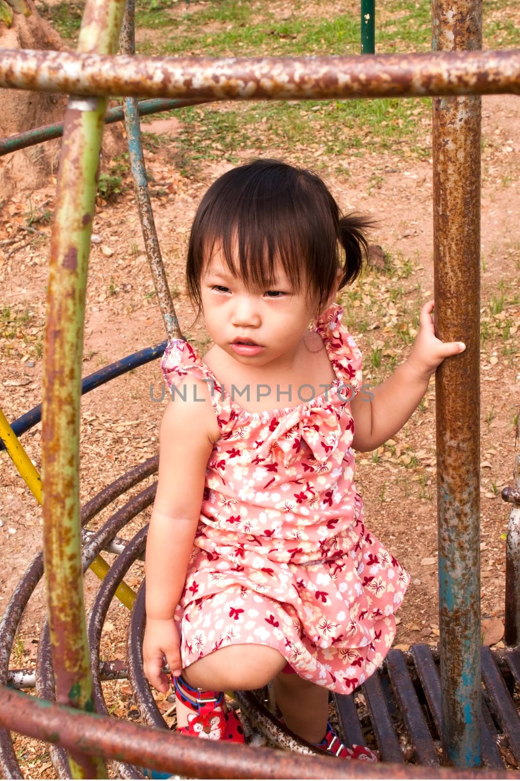 Asian Little girl playing in Playground of Thailand