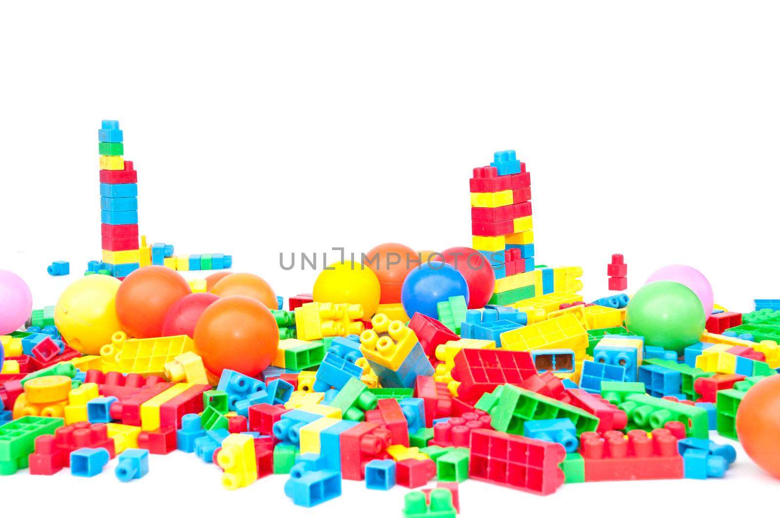 Plastic constructor bricks heap. isolated on white.