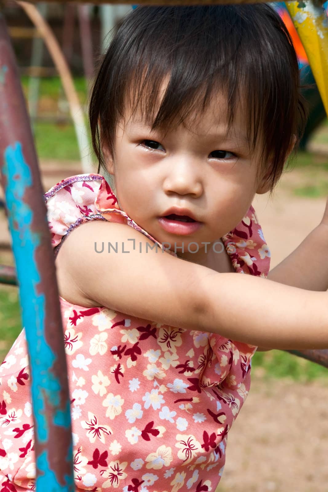 Asian Little girl playing in Playground of Thailand