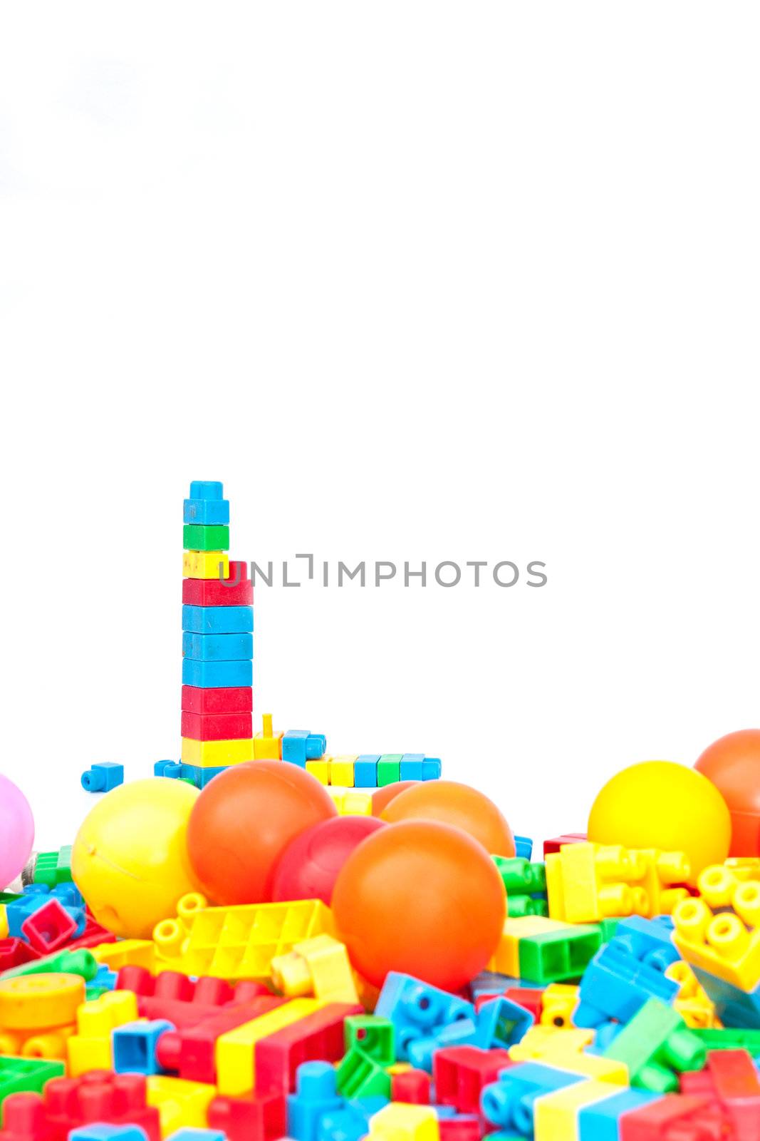 Plastic constructor bricks heap. isolated on white. by Yuri2012